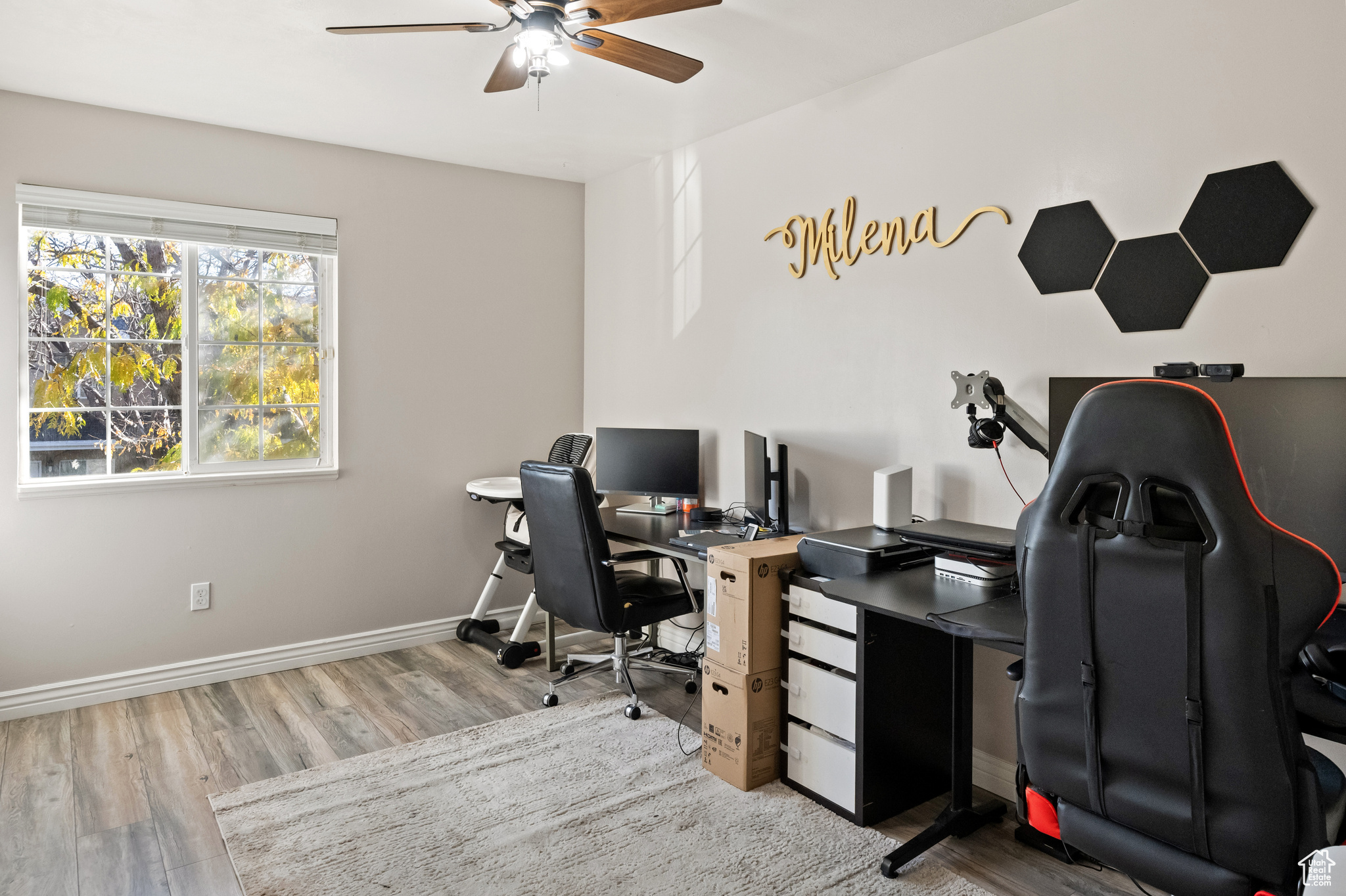 Office with ceiling fan and light hardwood / wood-style flooring