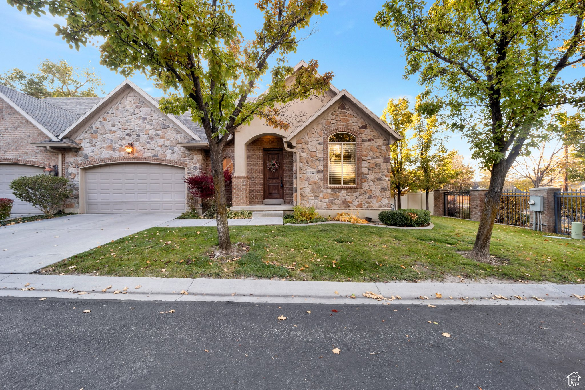 View of front of property featuring a garage and a front lawn