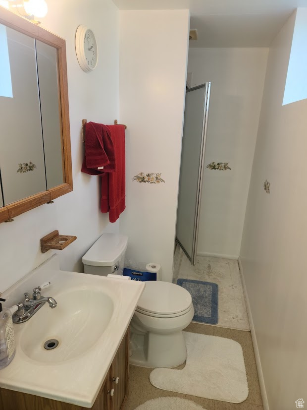 Bathroom with walk in shower, vanity, and toilet