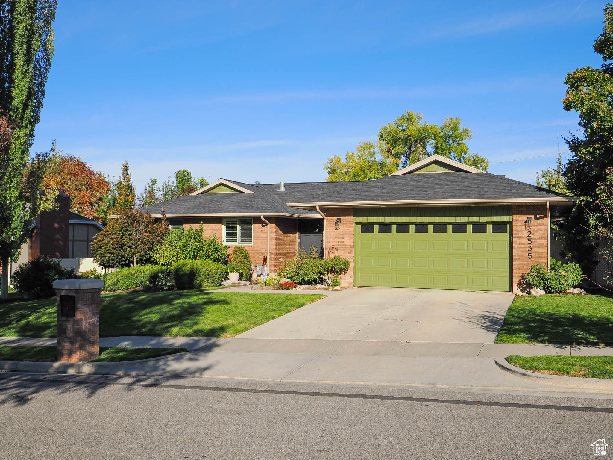 Ranch-style home with a garage and a front yard