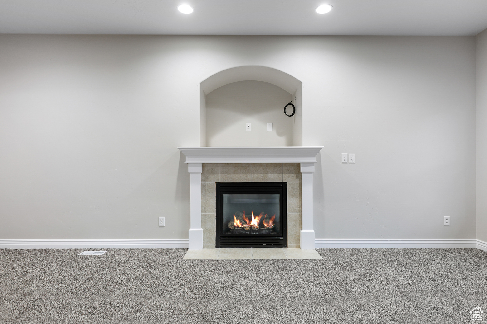 Interior details with carpet and a tiled fireplace