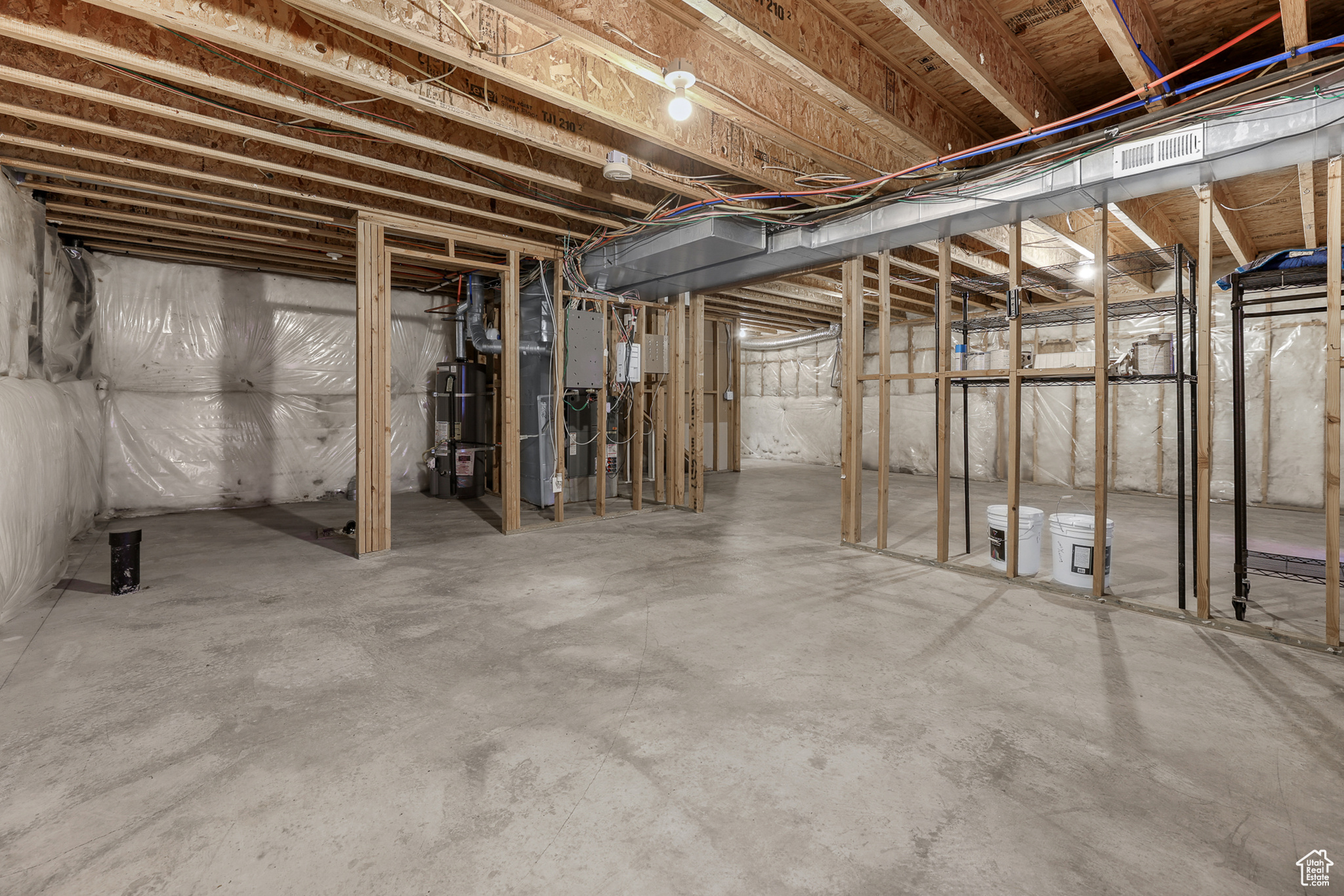 Basement featuring secured water heater