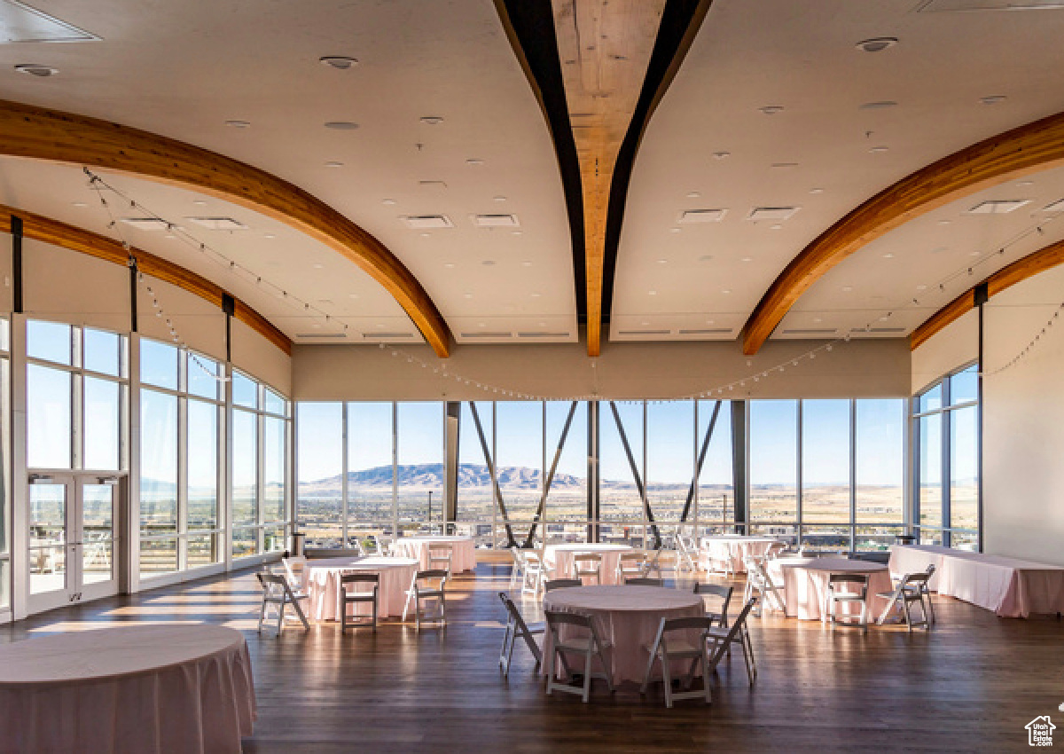 Dining space featuring a mountain view, a healthy amount of sunlight, and dark hardwood / wood-style floors