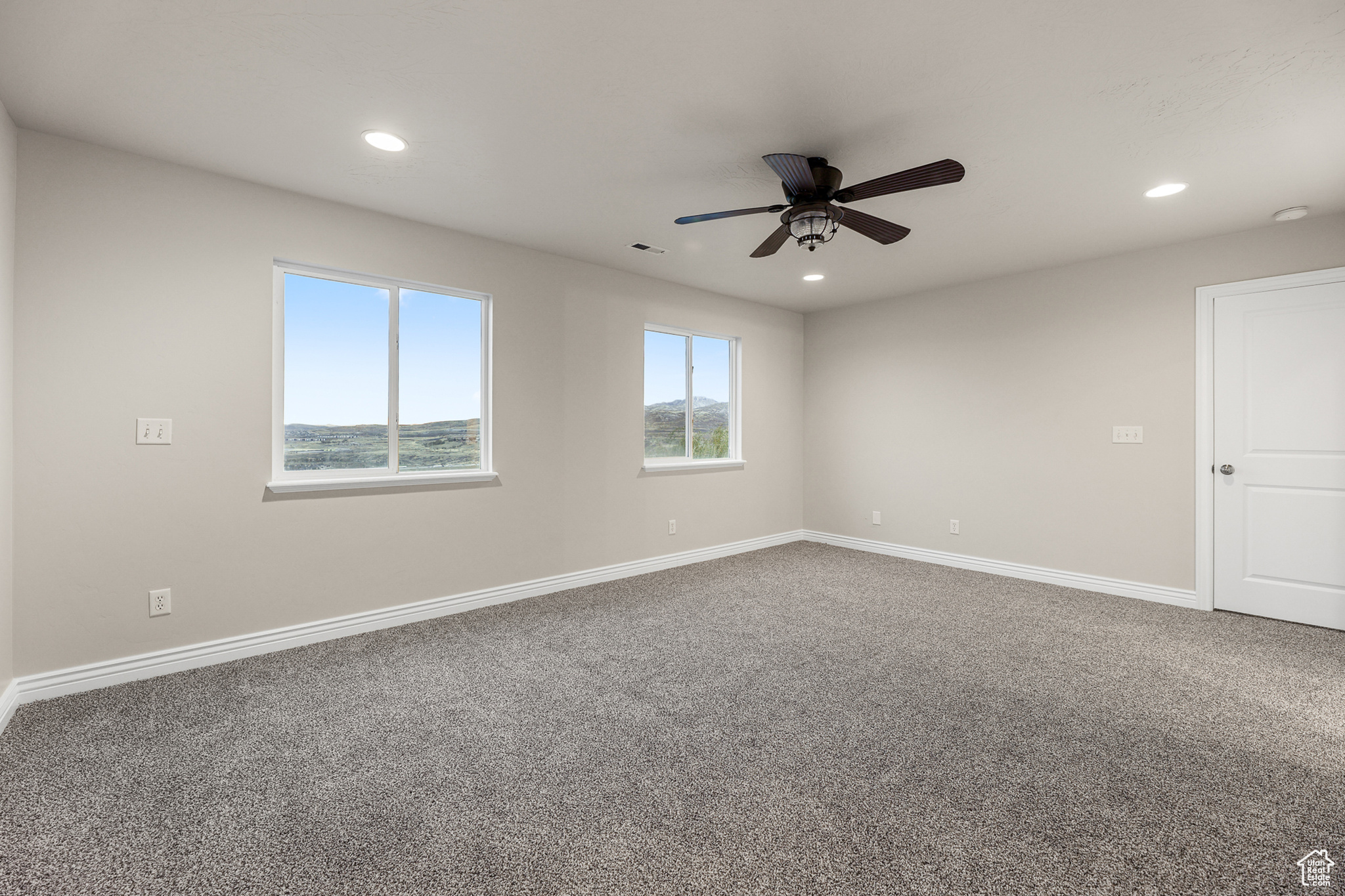 Primary suite featuring carpet flooring and ceiling fan