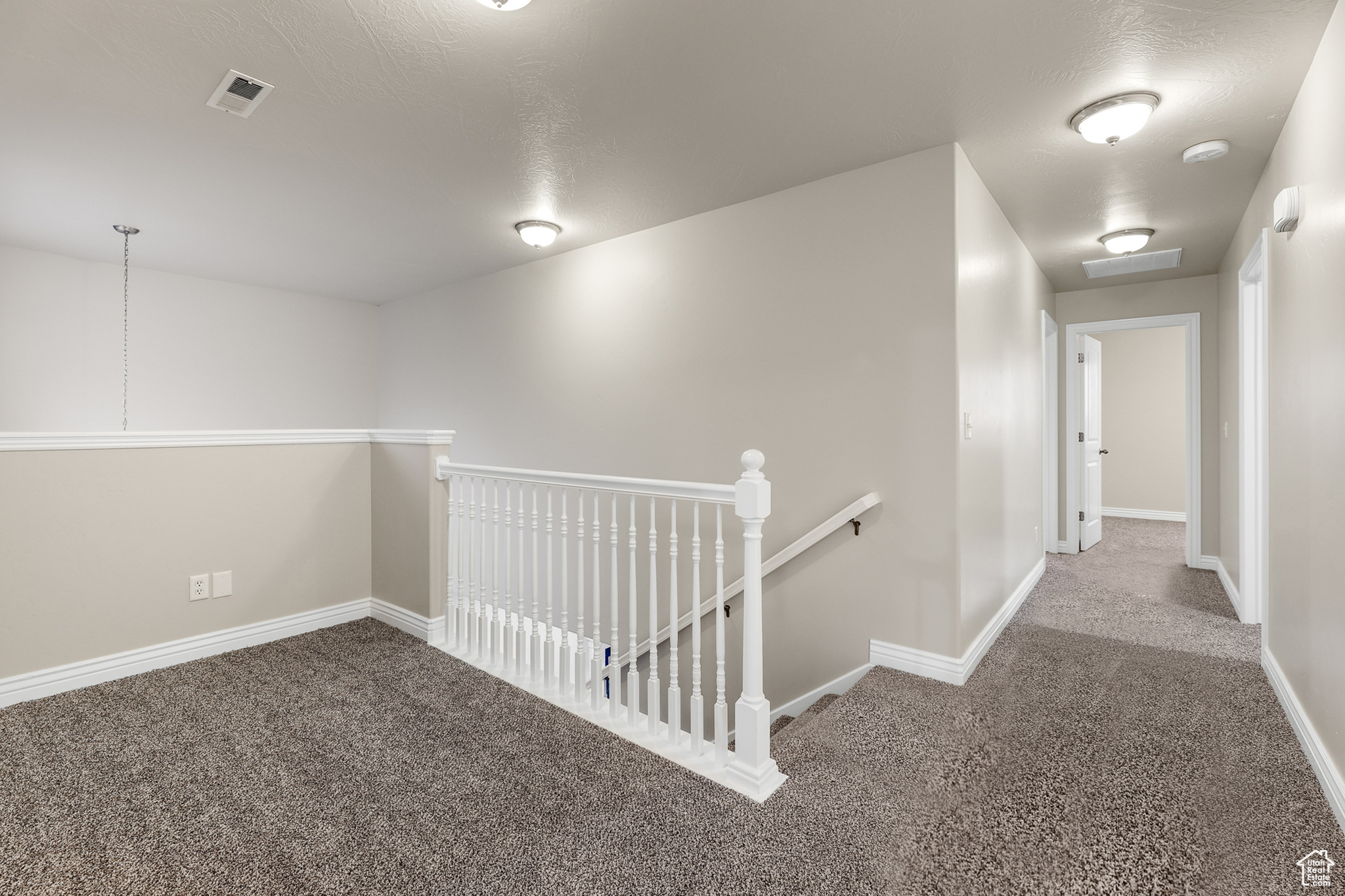 Corridor featuring carpet floors