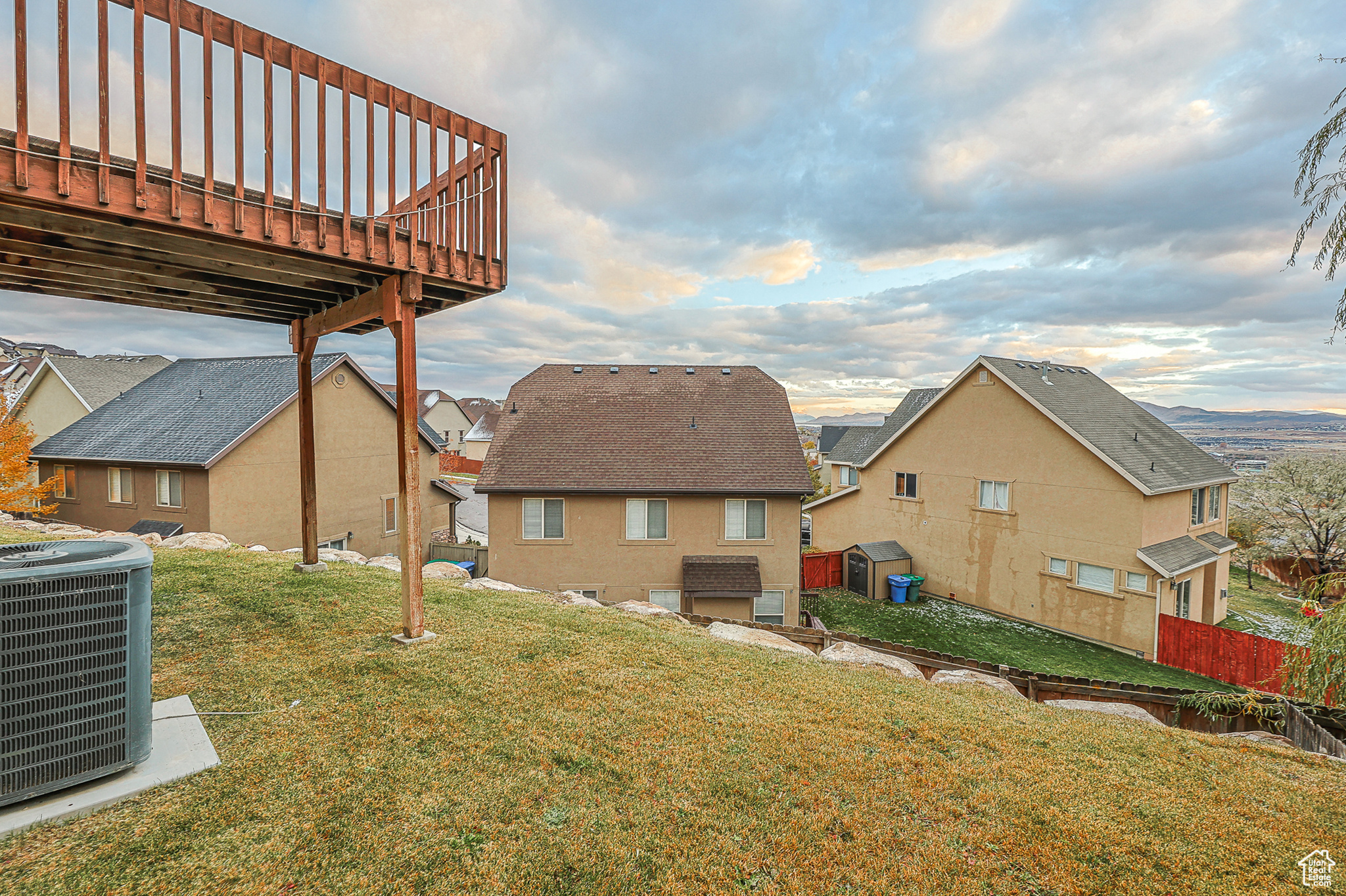 View of yard featuring a wooden deck and cooling unit