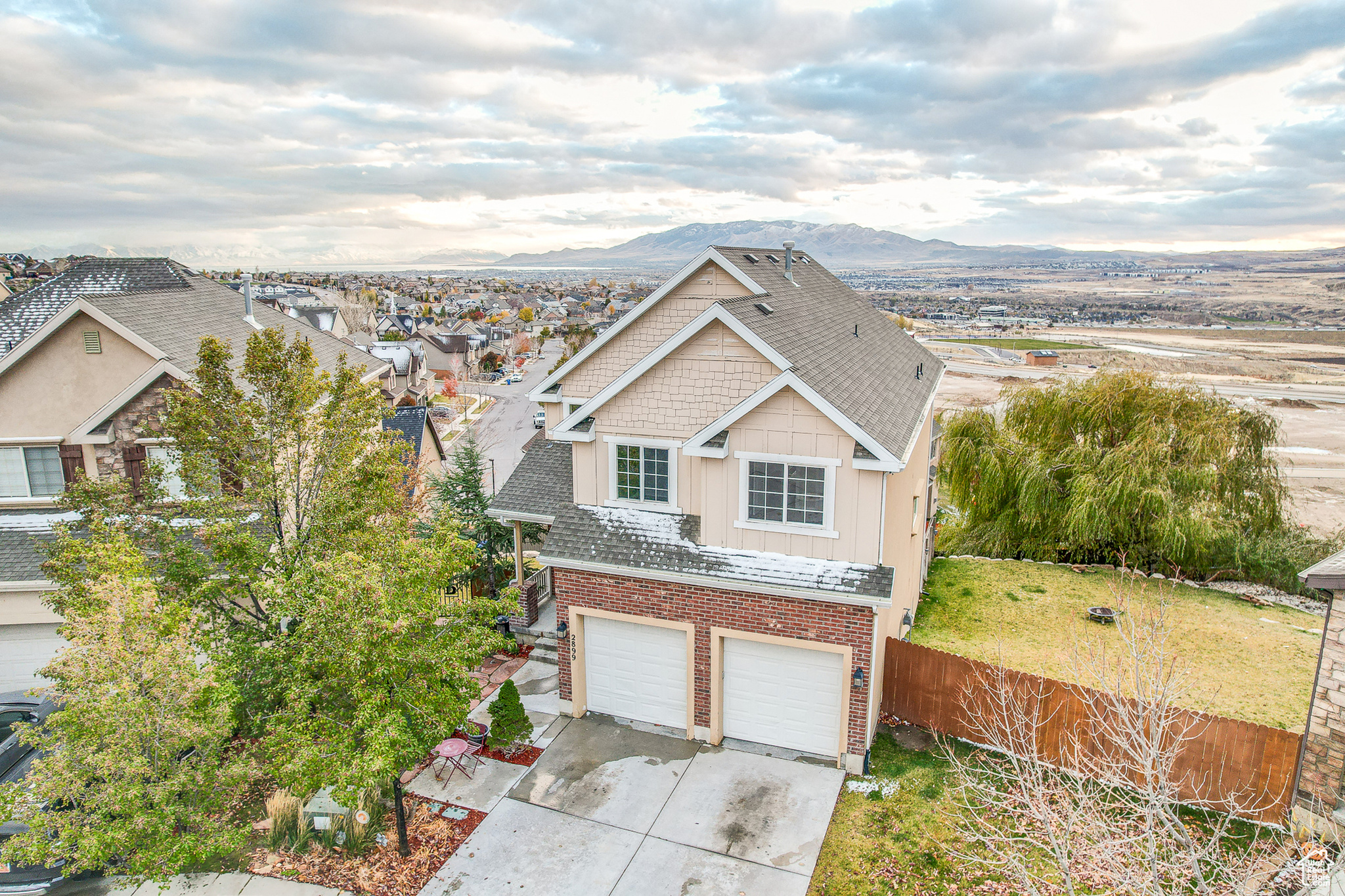 View of front facade with a garage and a mountain view