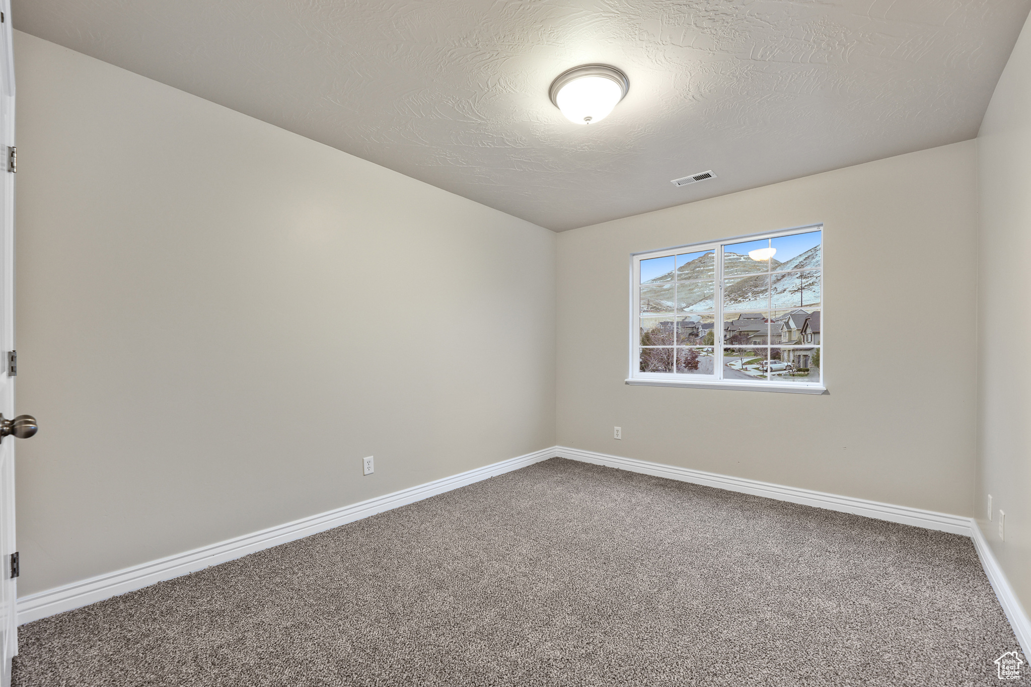 Unfurnished bedroom  with a textured ceiling