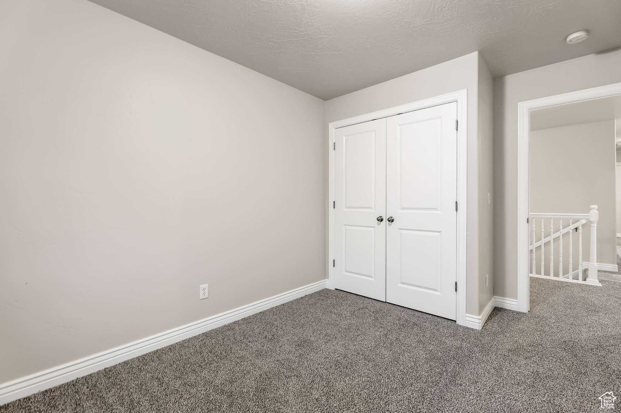 Unfurnished bedroom with a closet and carpet floors