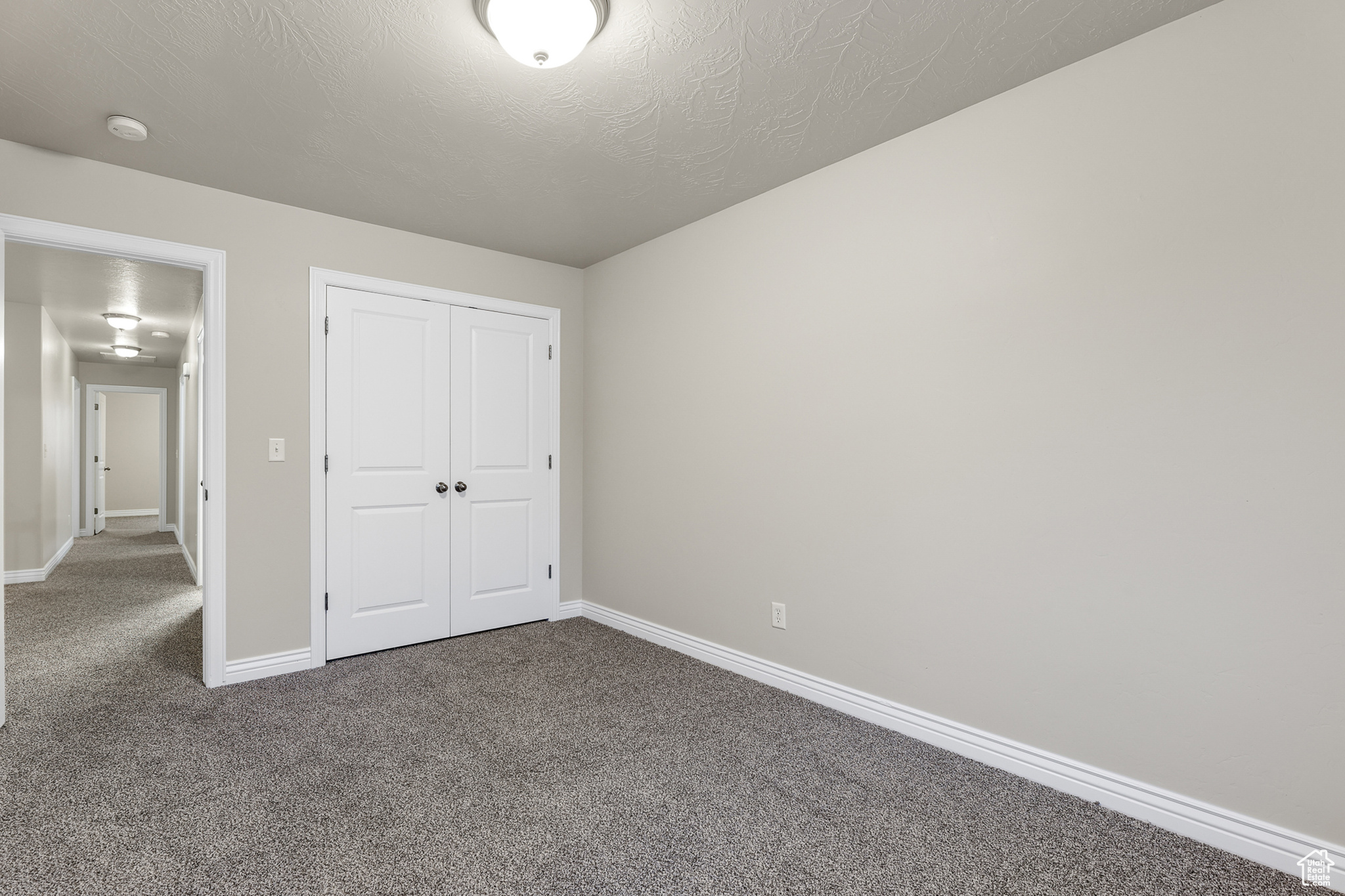 Unfurnished bedroom with a closet,and carpet floors