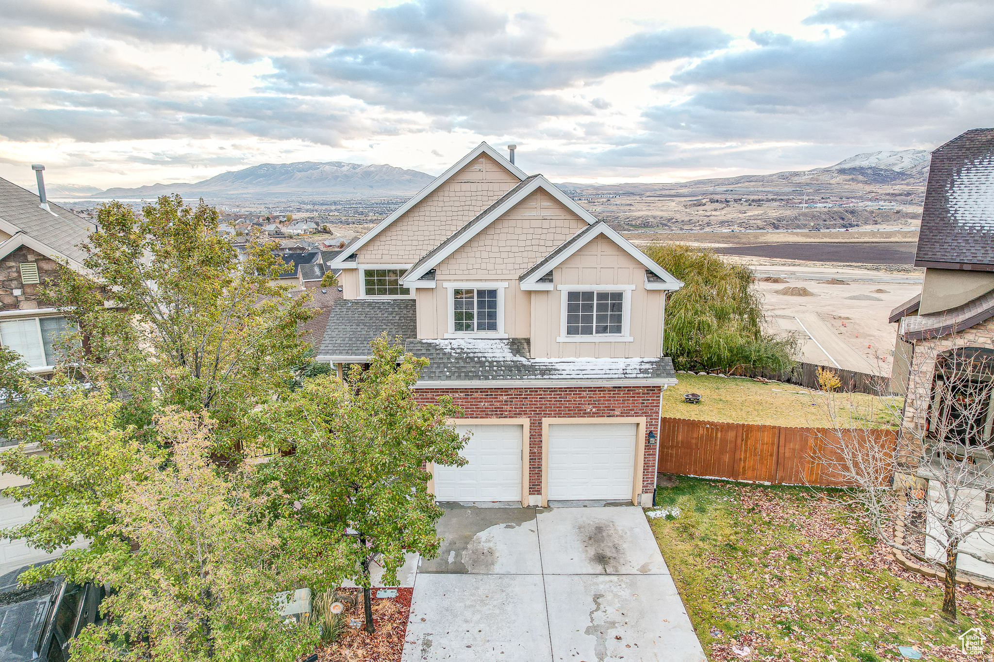 View of front of house with a mountain view and a garage