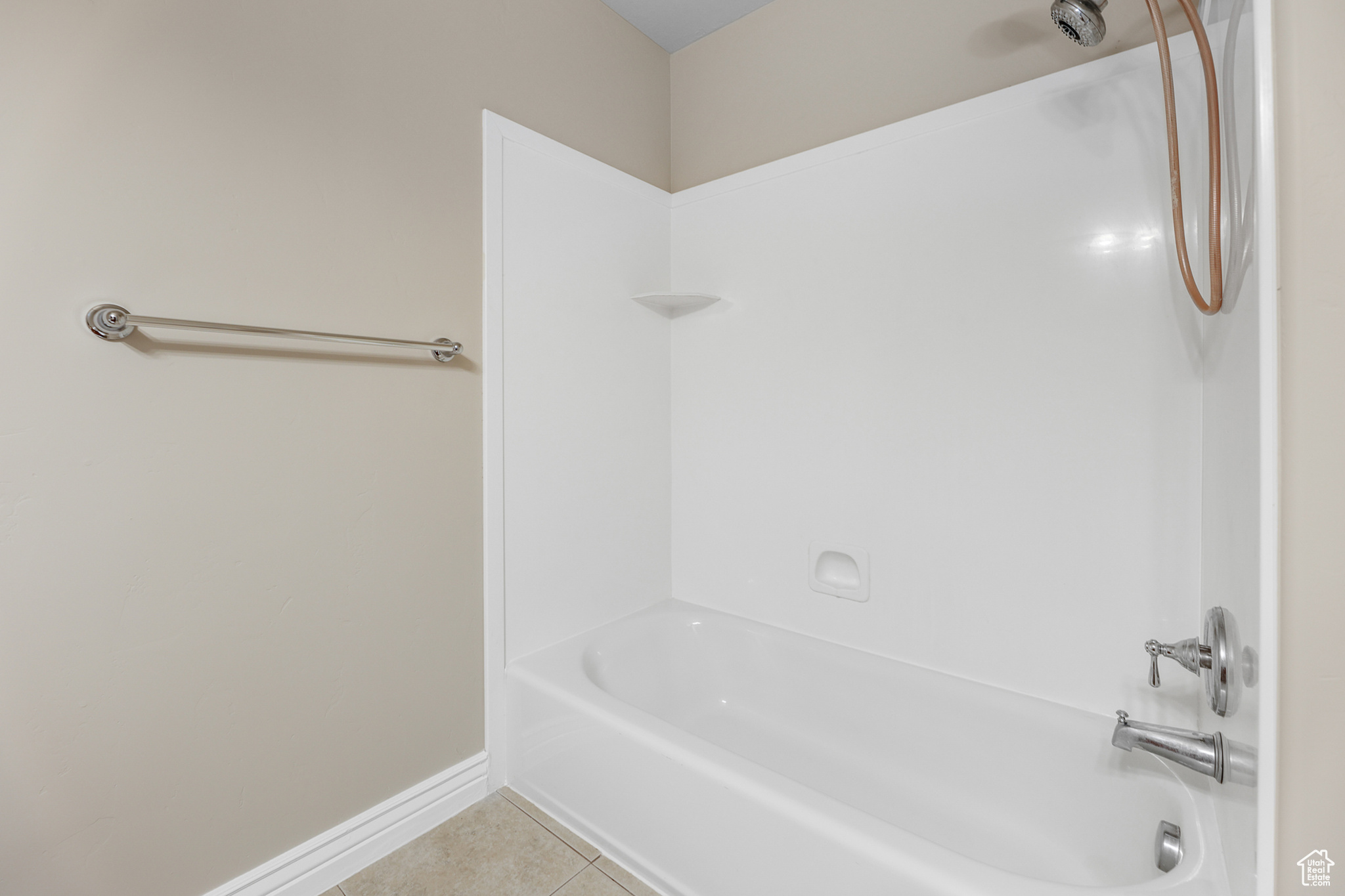 Bathroom featuring washtub / shower combination and tile patterned flooring