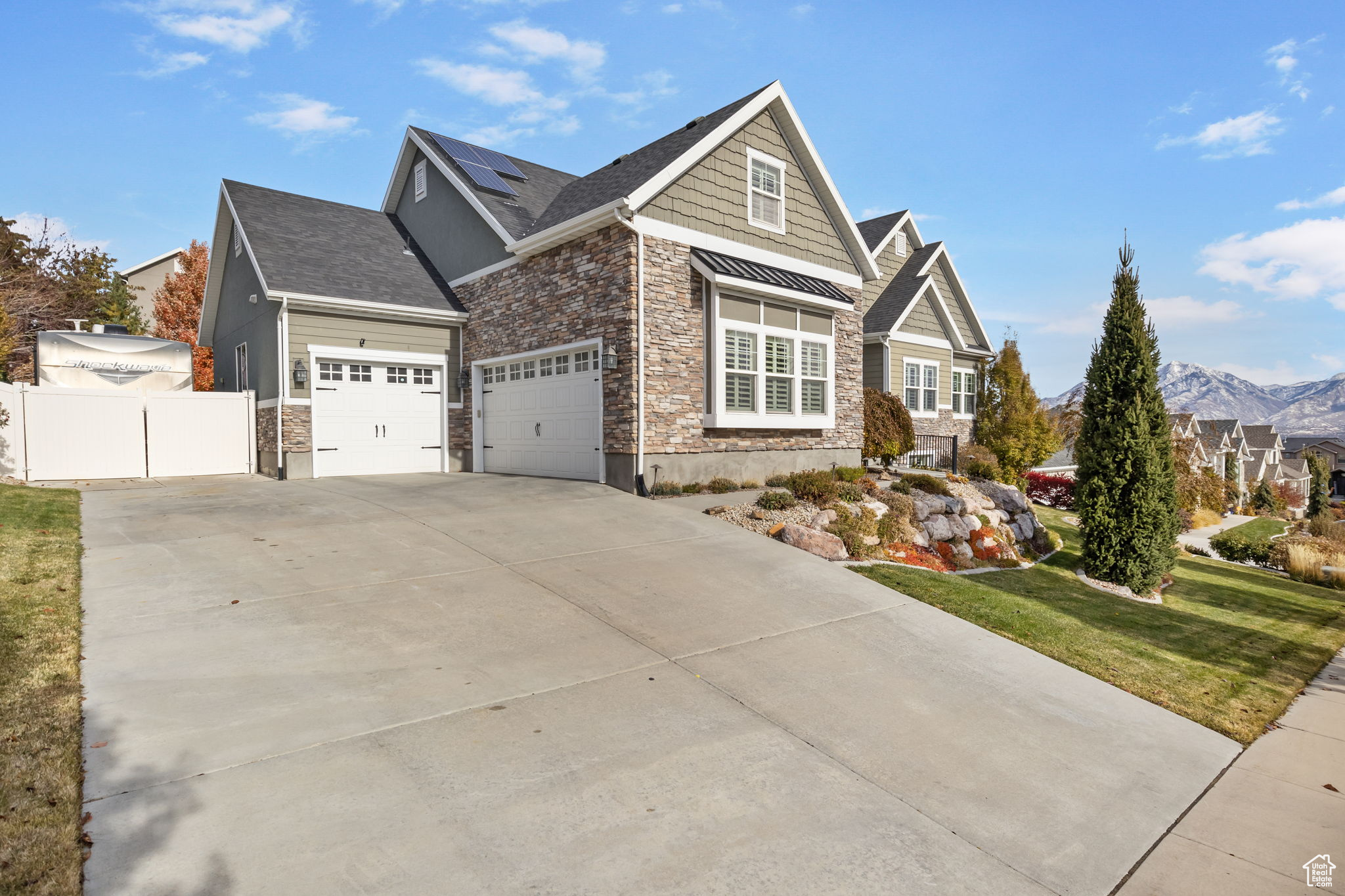 View of front of property with a mountain view and a front lawn