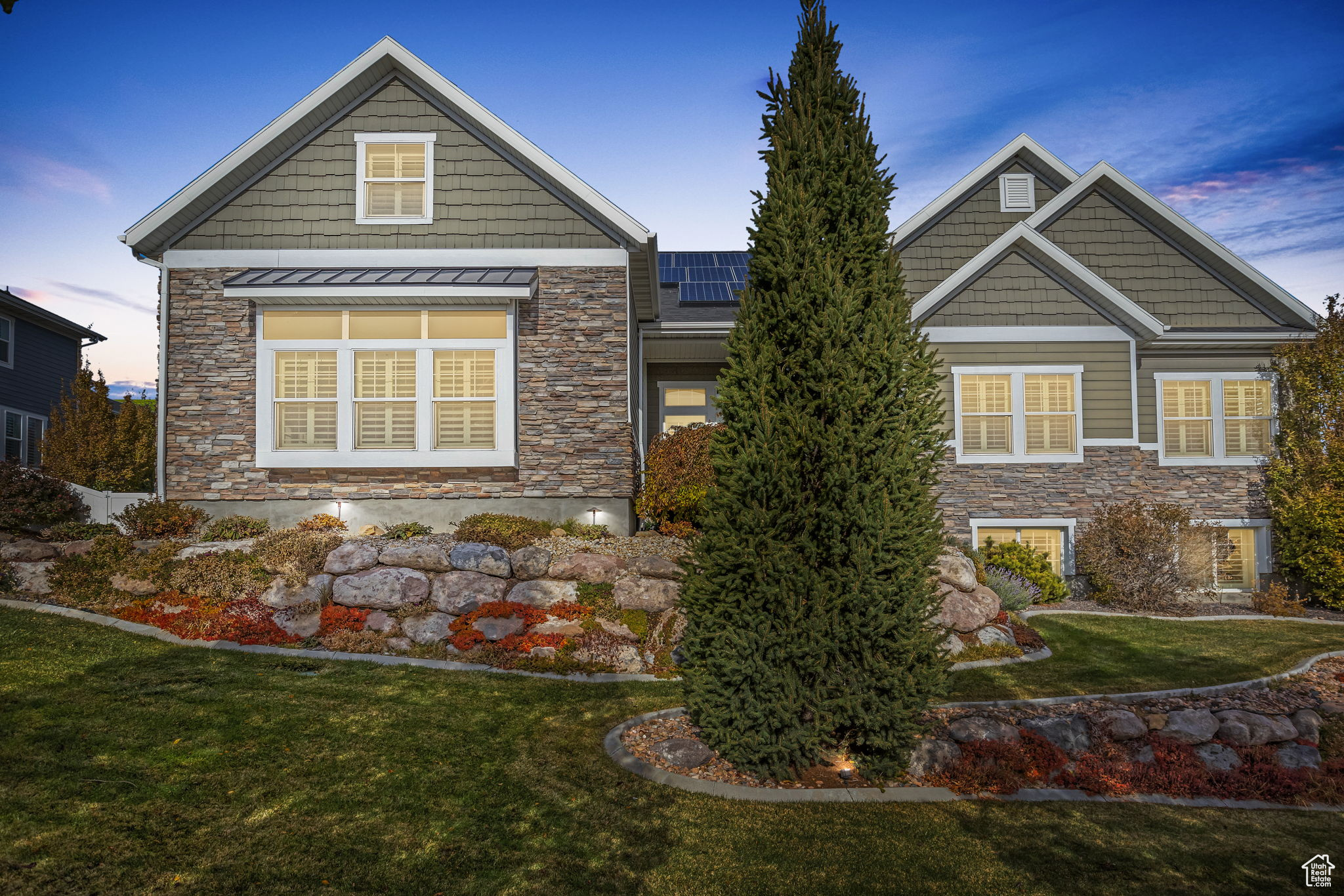 Craftsman house with solar panels and a lawn