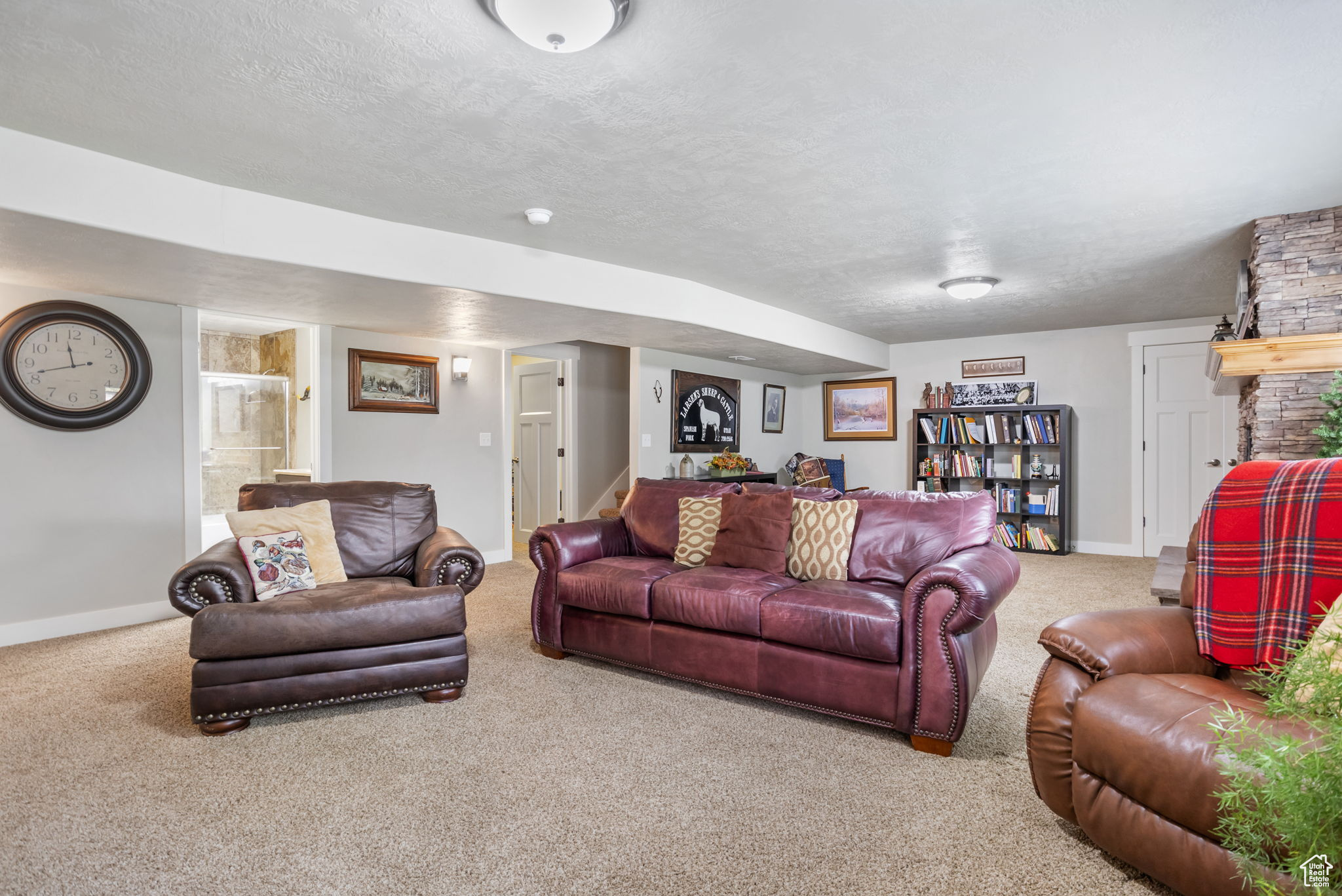 Carpeted living room with a fireplace and a textured ceiling