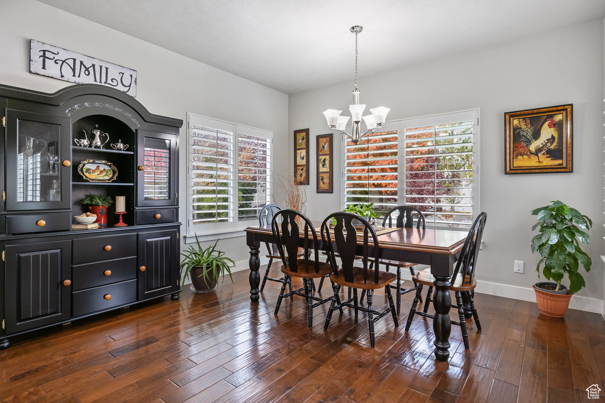 Dining room featuring dark hardwood / wood-style flooring and an inviting chandelier