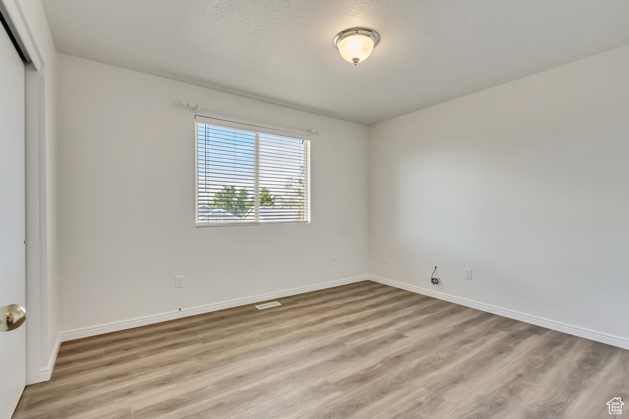 Empty room featuring light wood-type flooring