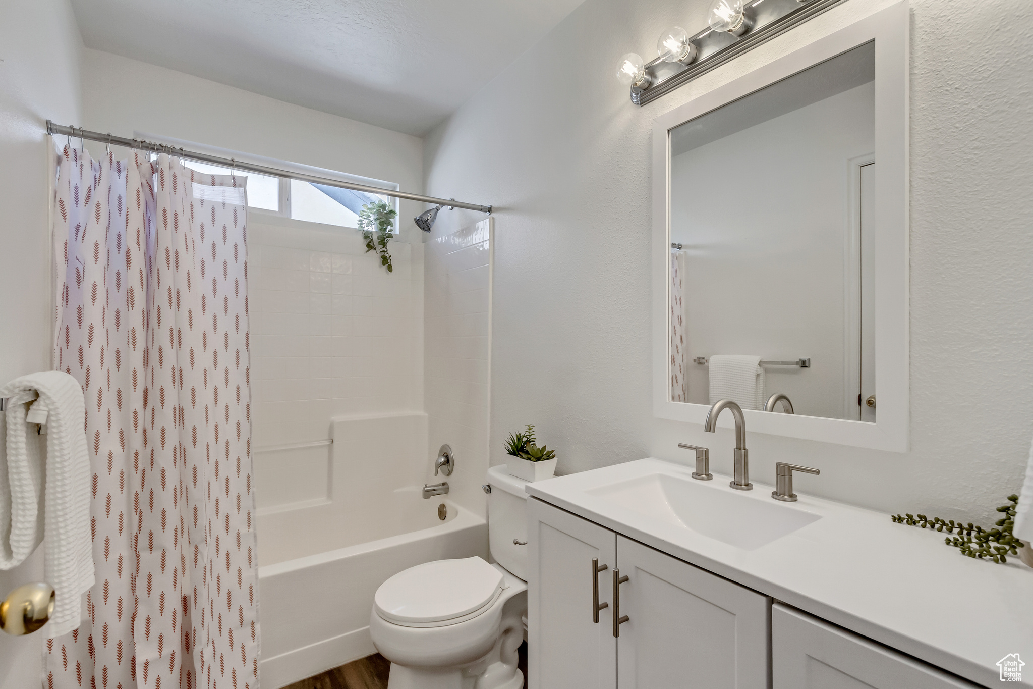 Full bathroom with vanity, toilet, and shower / tub combo with curtain