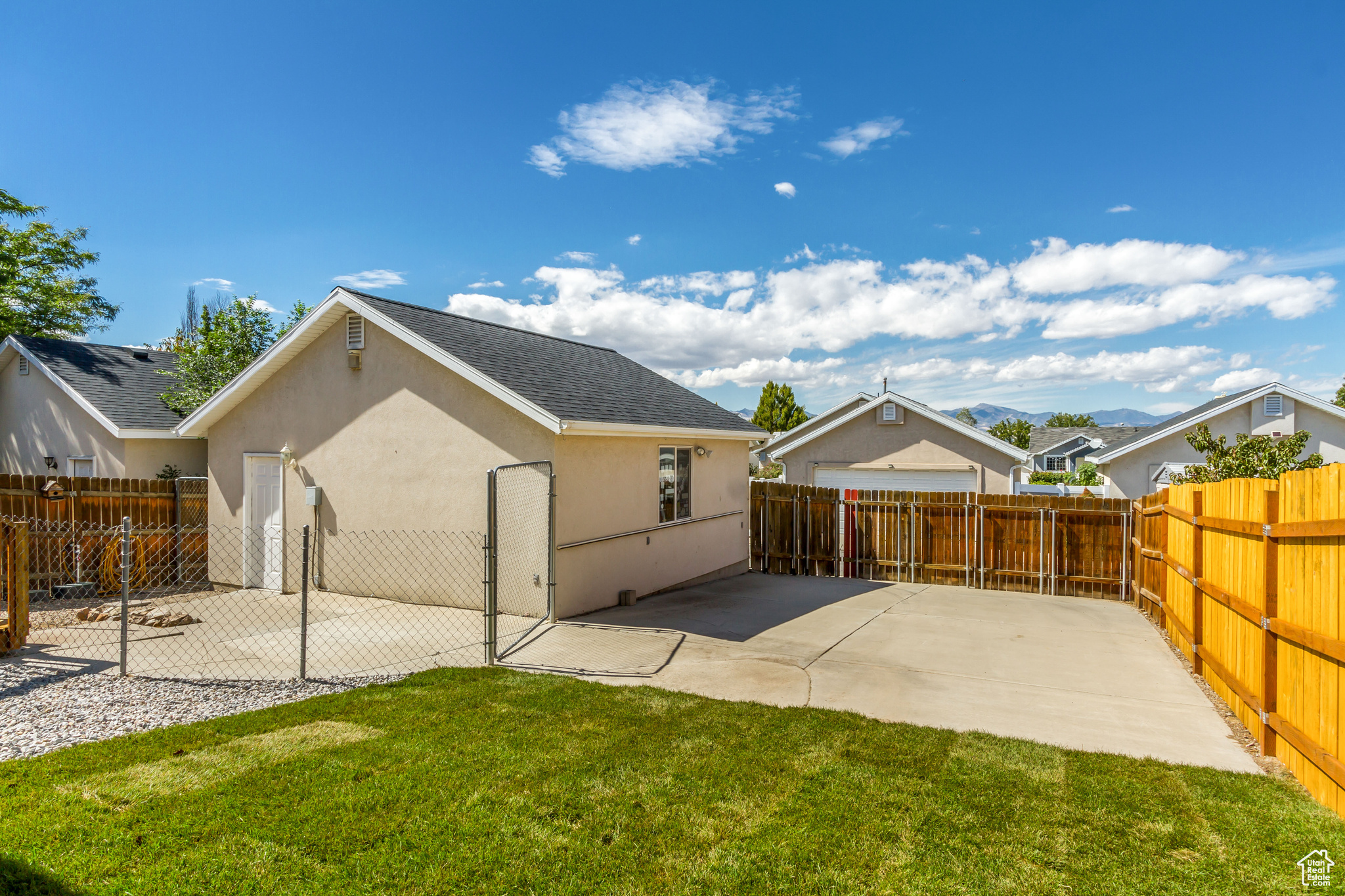 Back of property featuring a yard and a patio