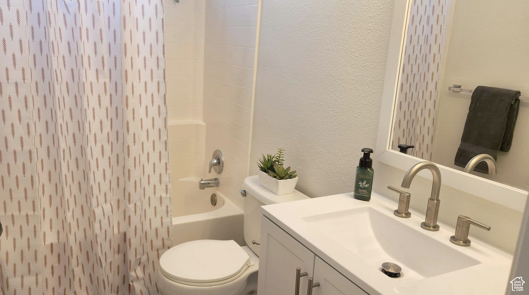 Full bathroom with toilet, vanity, and bathing tub / shower combination