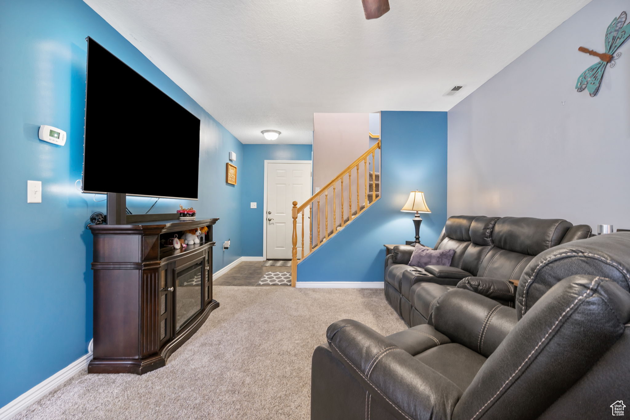 Carpeted living room featuring a textured ceiling