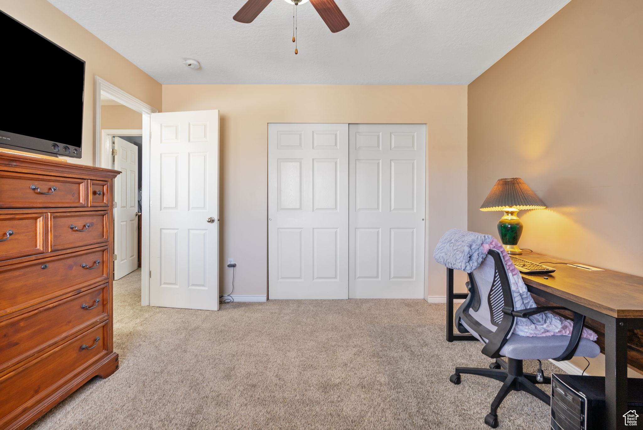 Carpeted office with ceiling fan