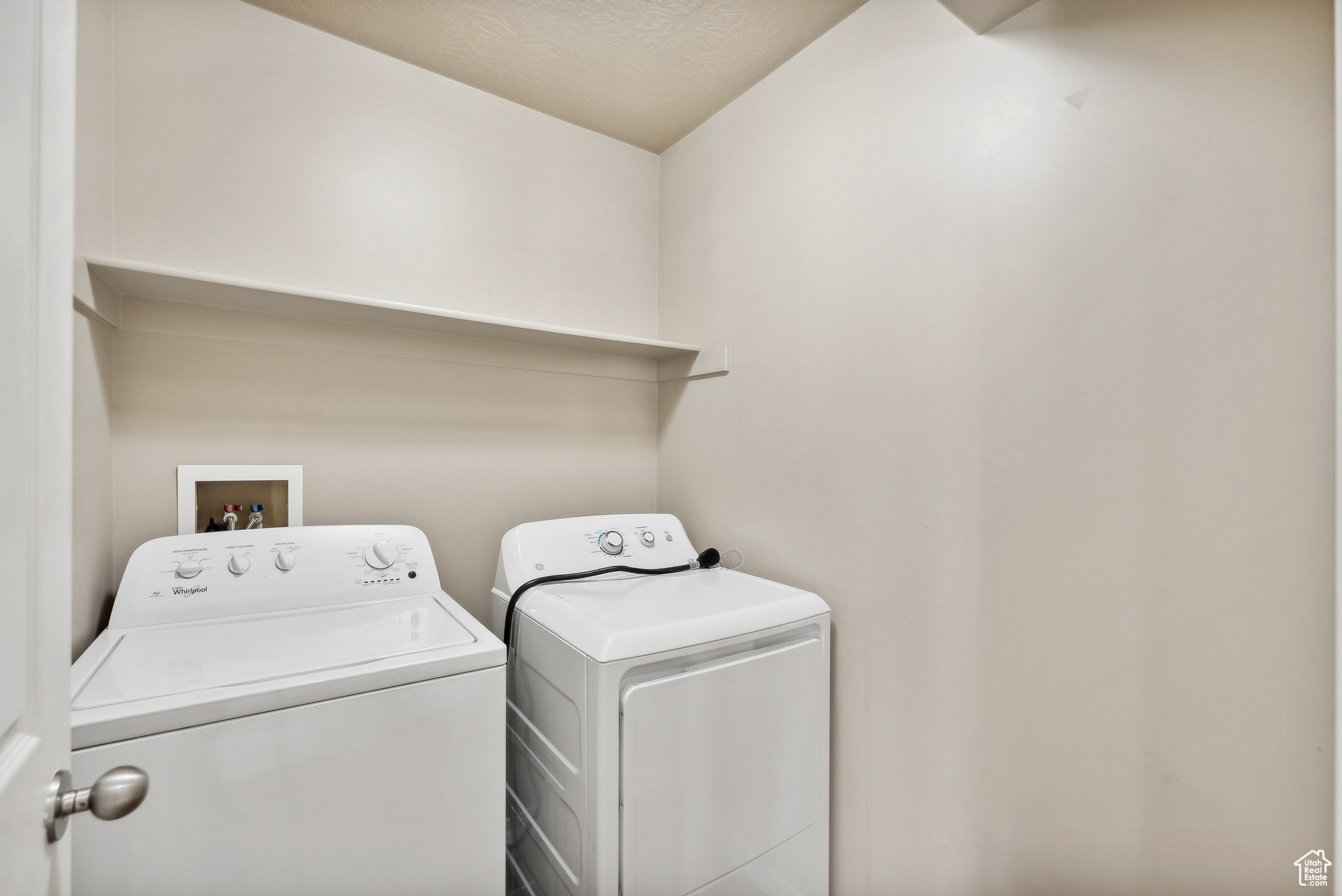 Laundry room featuring washer and dryer and a textured ceiling