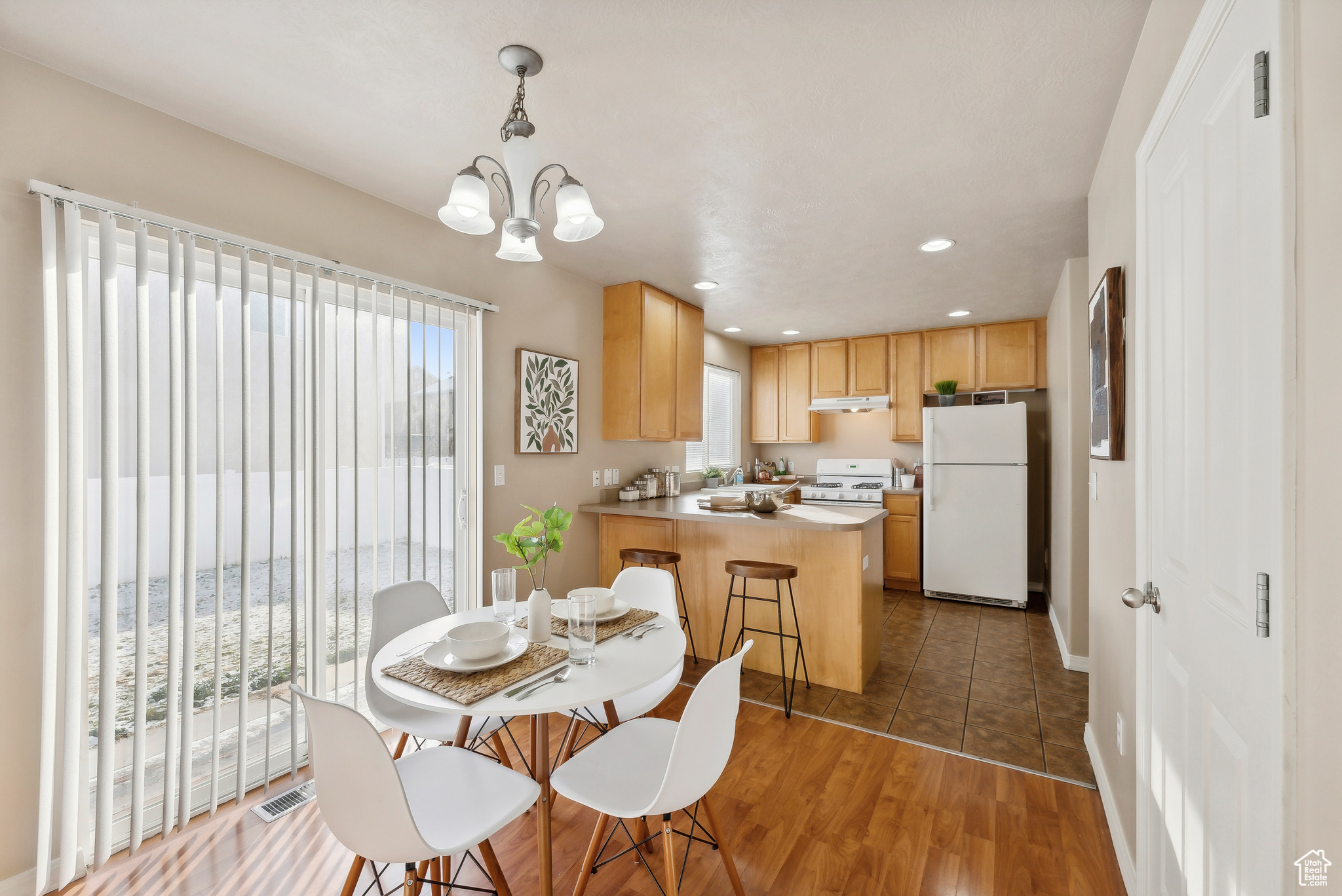 Dining room featuring plenty of natural light, dark hardwood / wood-style floors, and an inviting chandelier