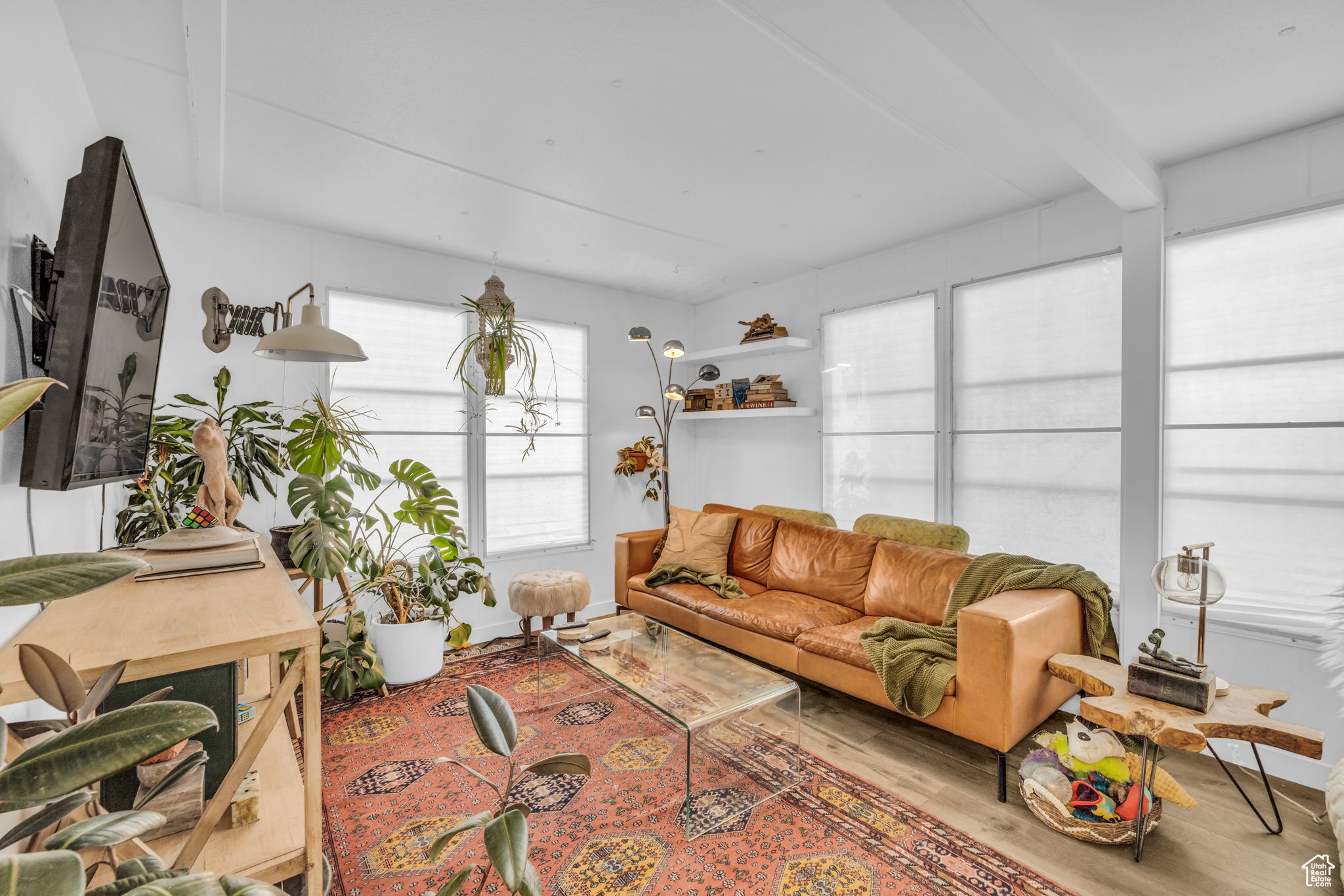 Living room featuring light hardwood / wood-style floors and beam ceiling