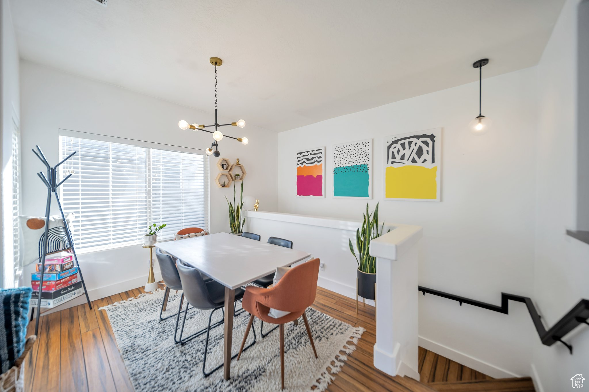 Dining space with wood-type flooring and an inviting chandelier