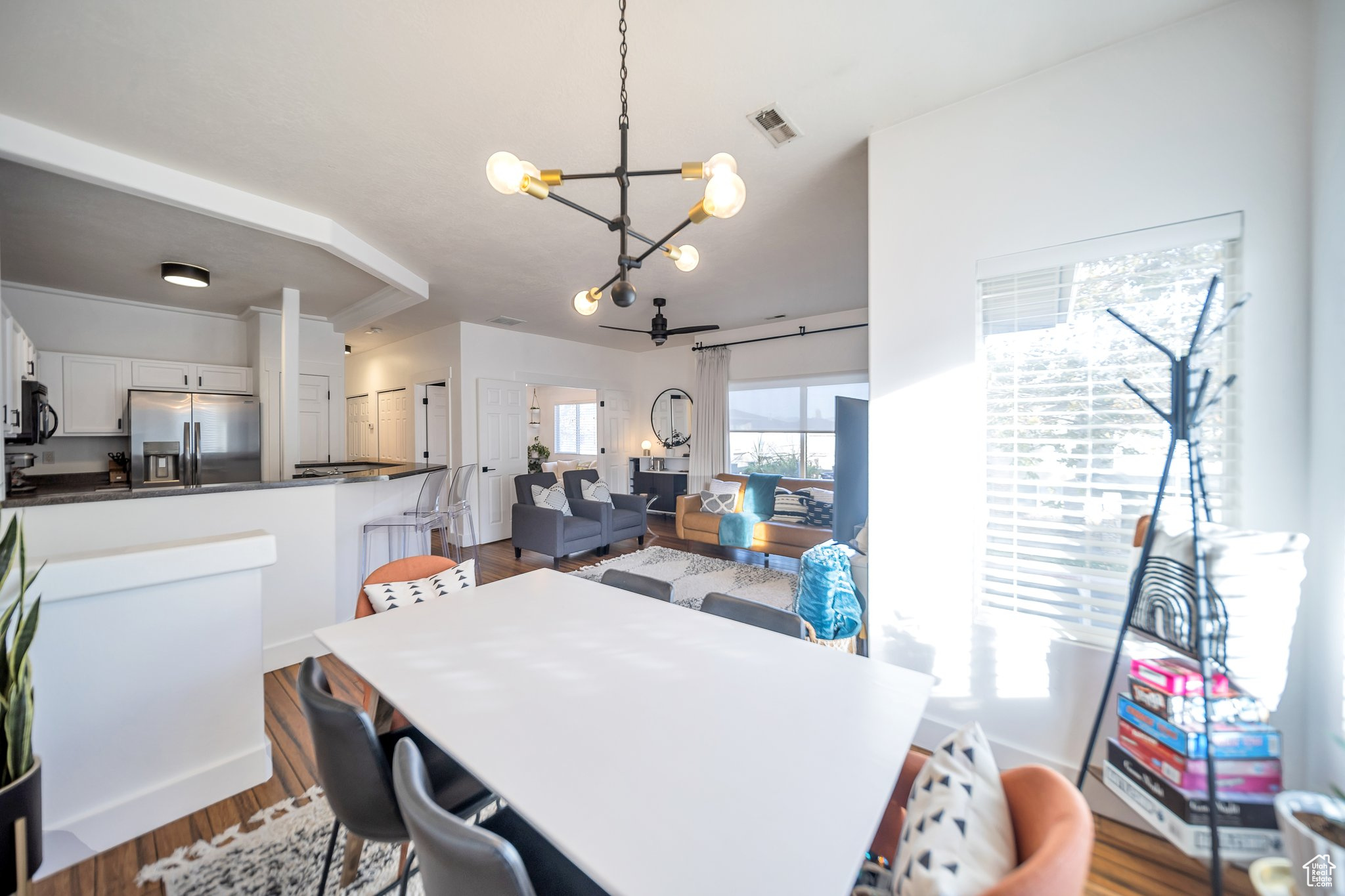 Dining area with dark wood-type flooring and an inviting chandelier