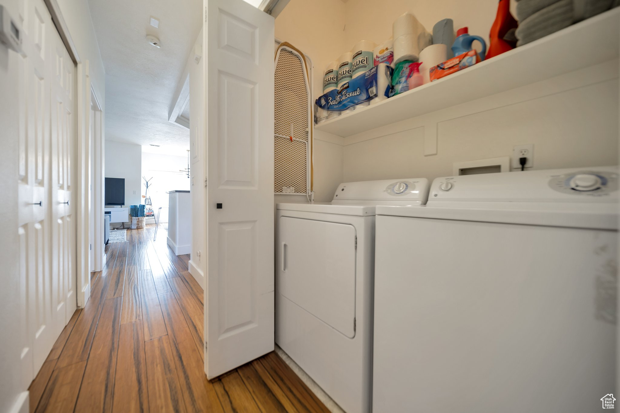 Clothes washing area featuring independent washer and dryer and dark hardwood / wood-style floors