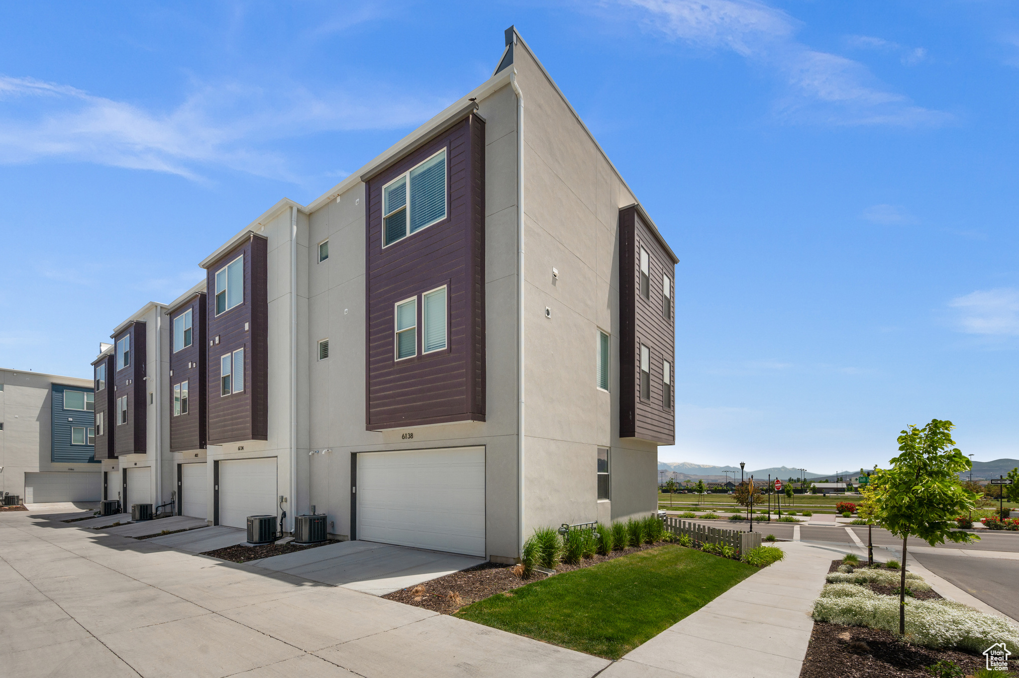 View of home's exterior featuring cooling unit and a garage