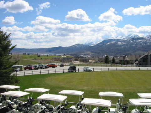 Surrounding community featuring a lawn and a mountain view