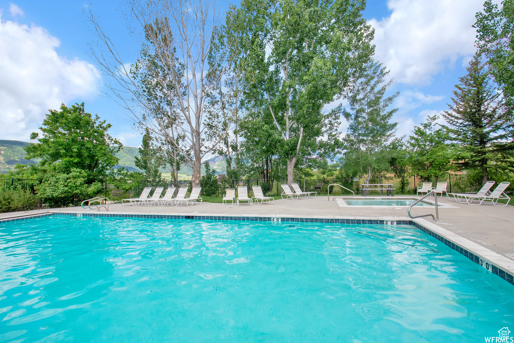 View of pool featuring a mountain view and a patio