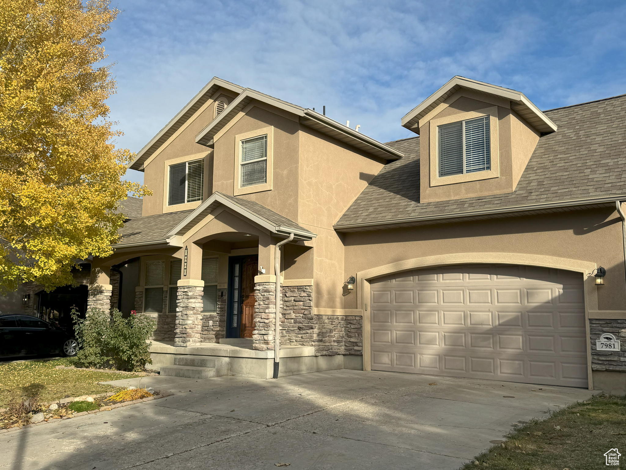 View of front of home featuring a porch and a garage