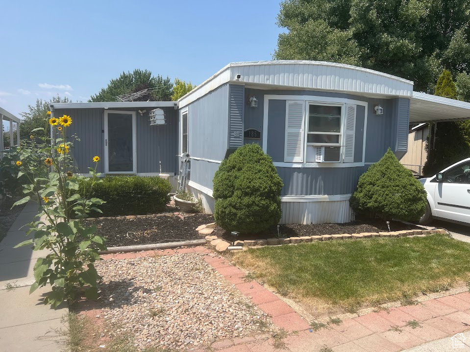 View of front of property with a front lawn and a carport