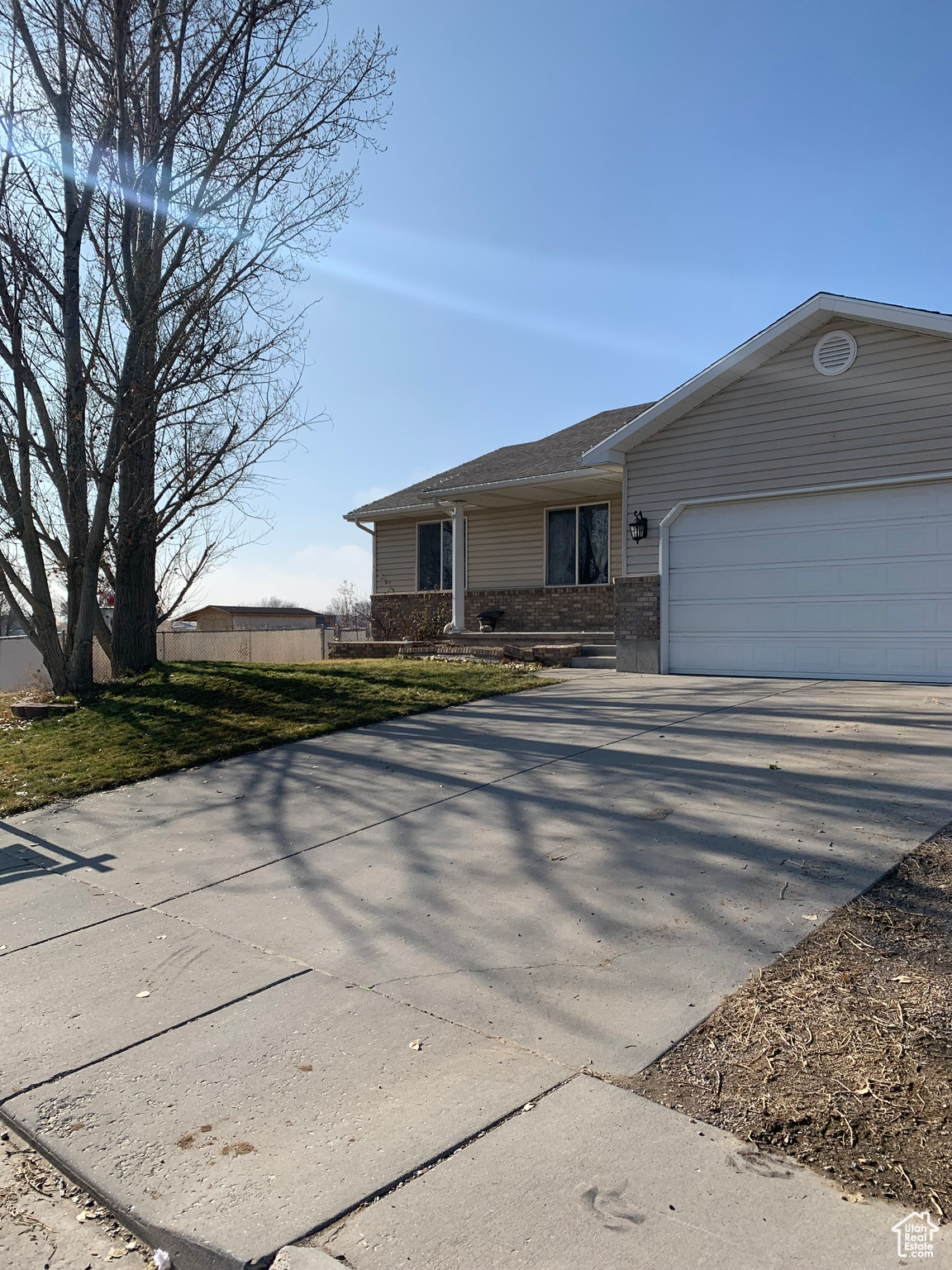 View of front facade featuring a front yard and a garage