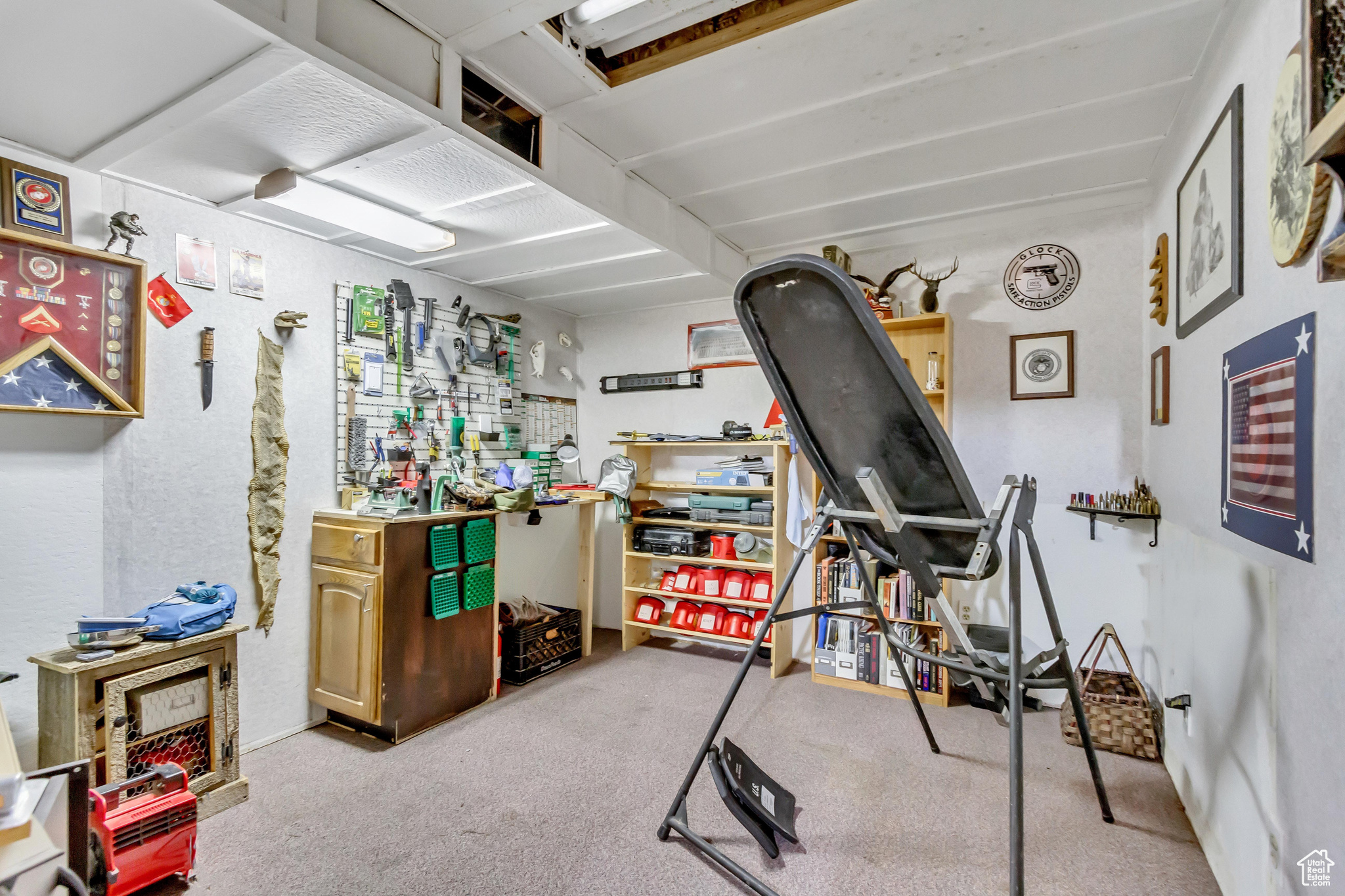 Exercise room with a workshop area and light colored carpet