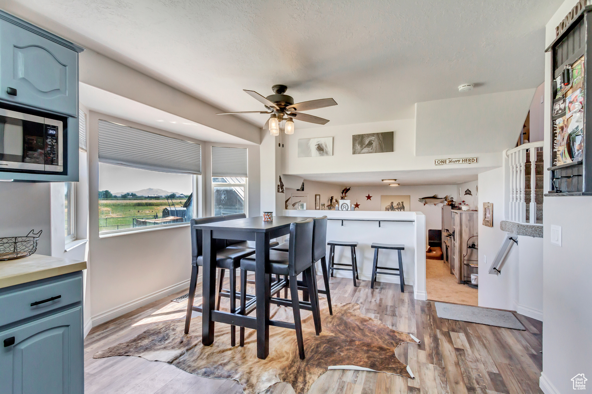 Dining space featuring ceiling fan and light hardwood / wood-style flooring