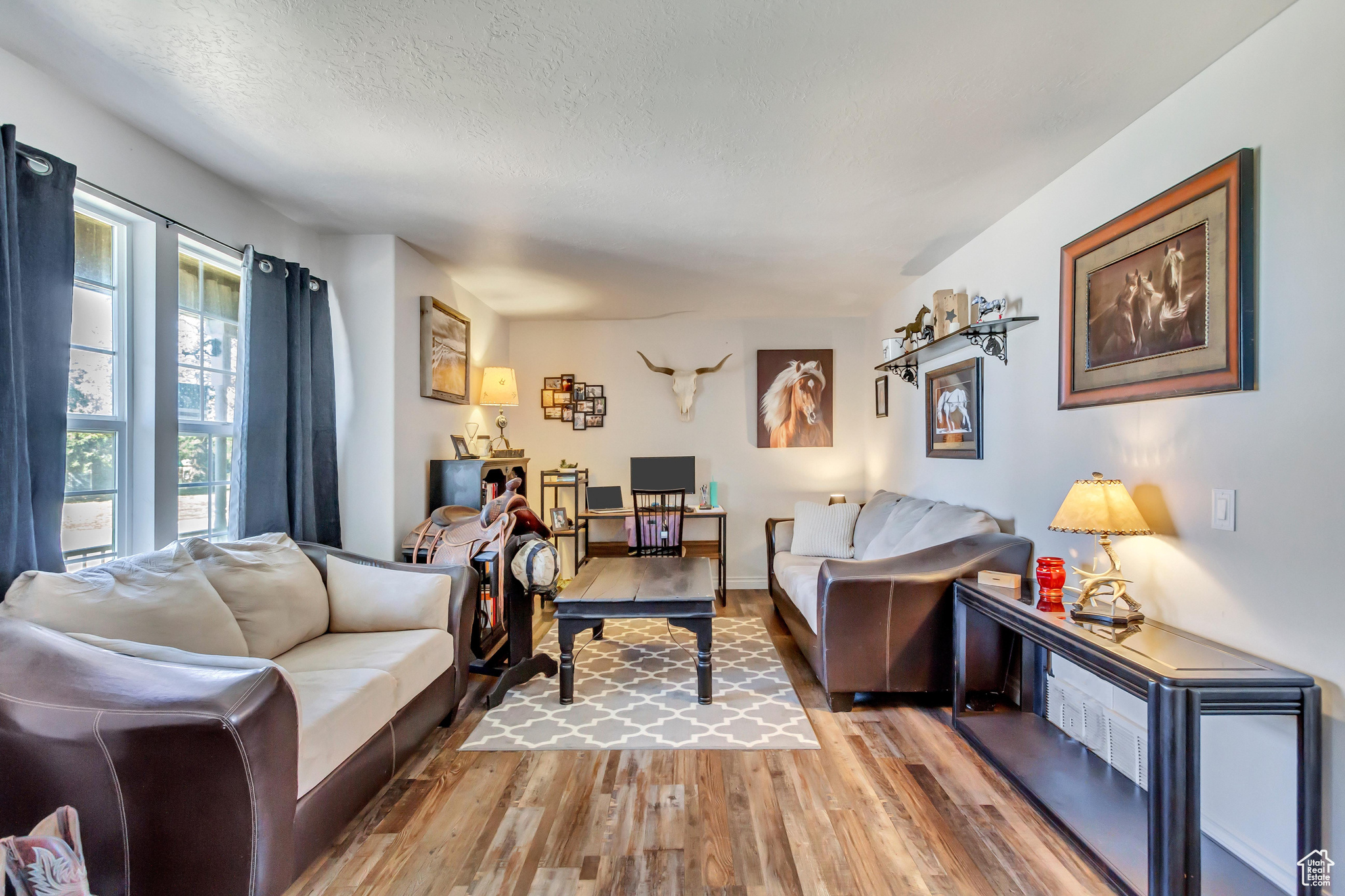 Living room with wood-type flooring and a textured ceiling