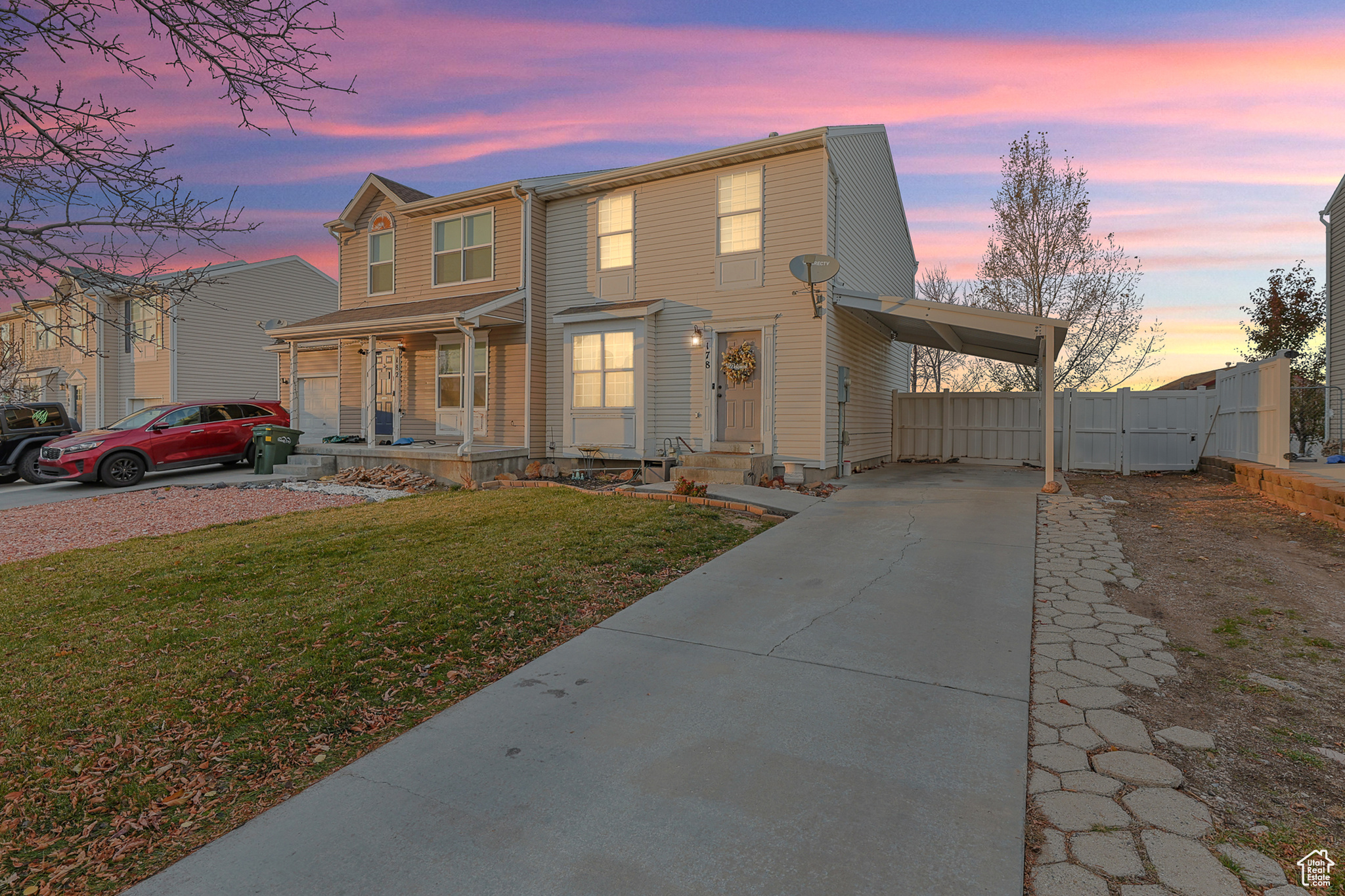 View of front of house featuring covered porch and a yard