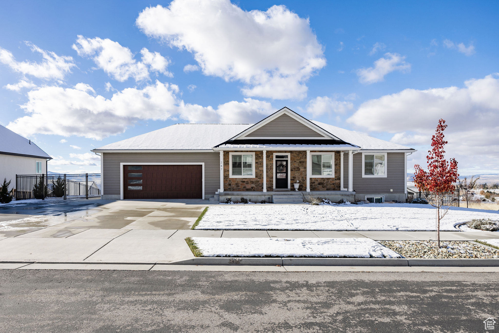 Ranch-style house with covered porch and a garage