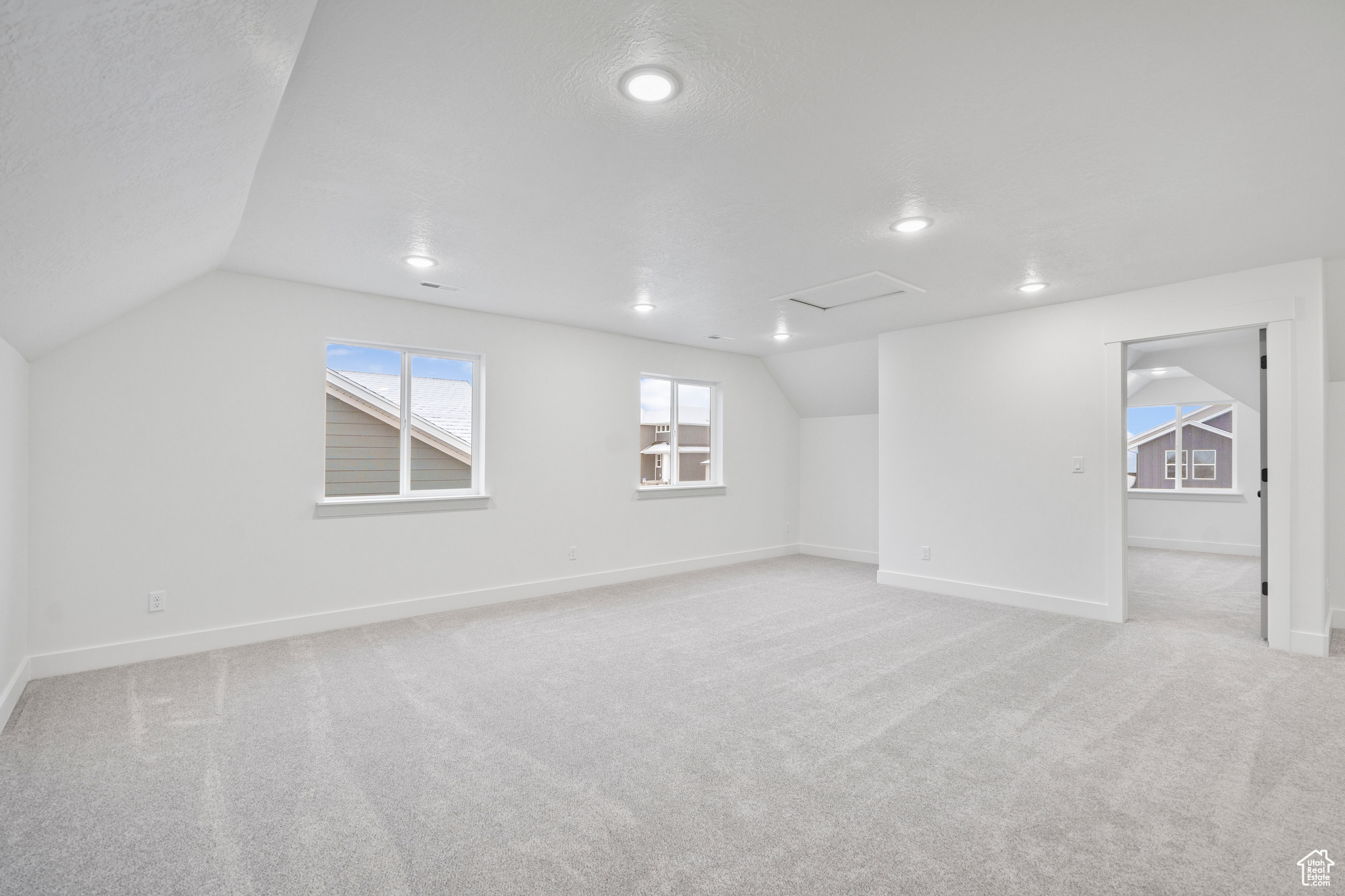 Basement featuring a textured ceiling and light carpet