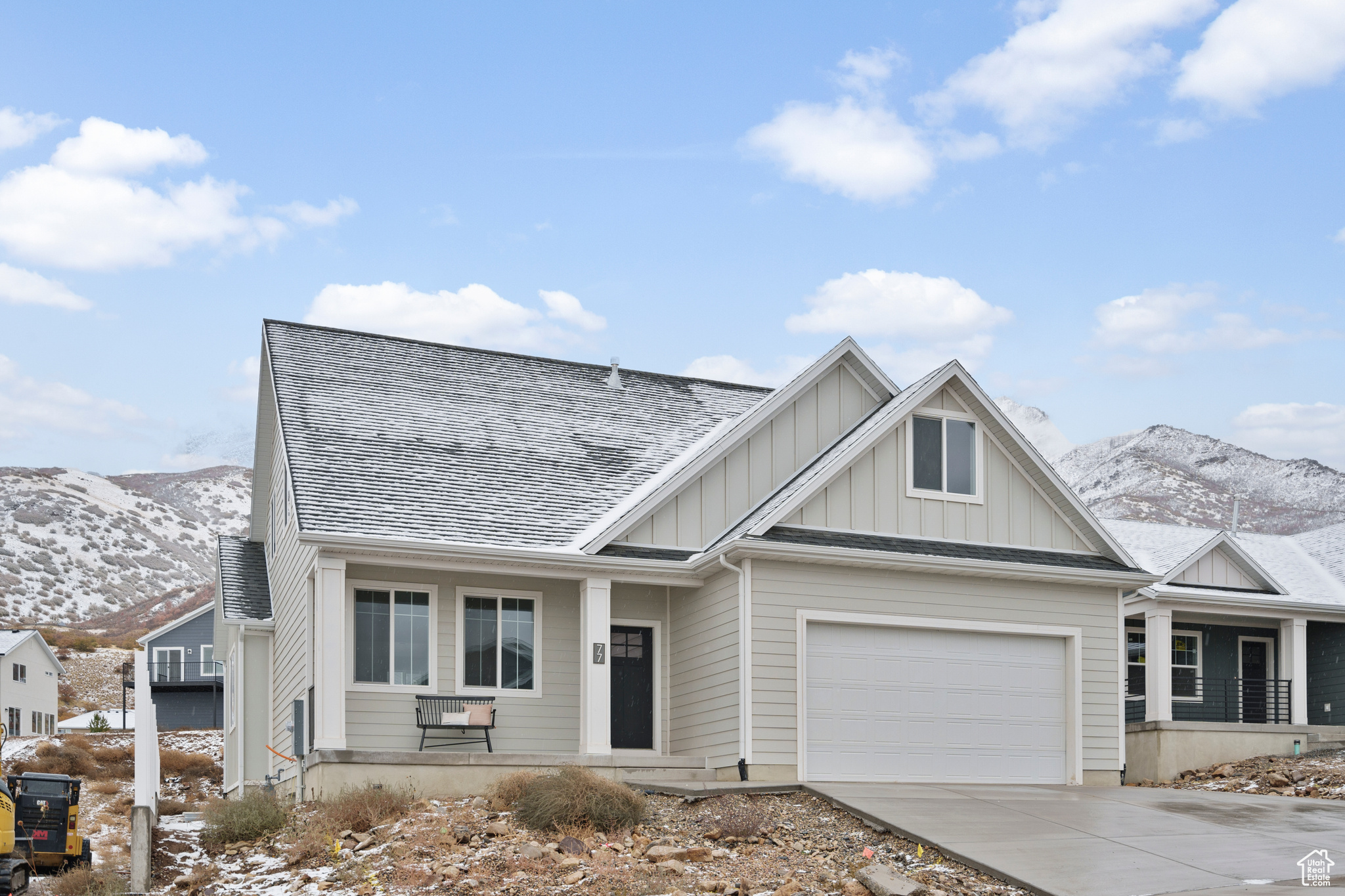 View of front of property featuring a mountain view and a garage