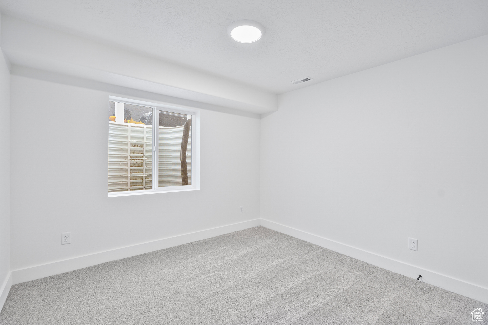 Unfurnished room with carpet