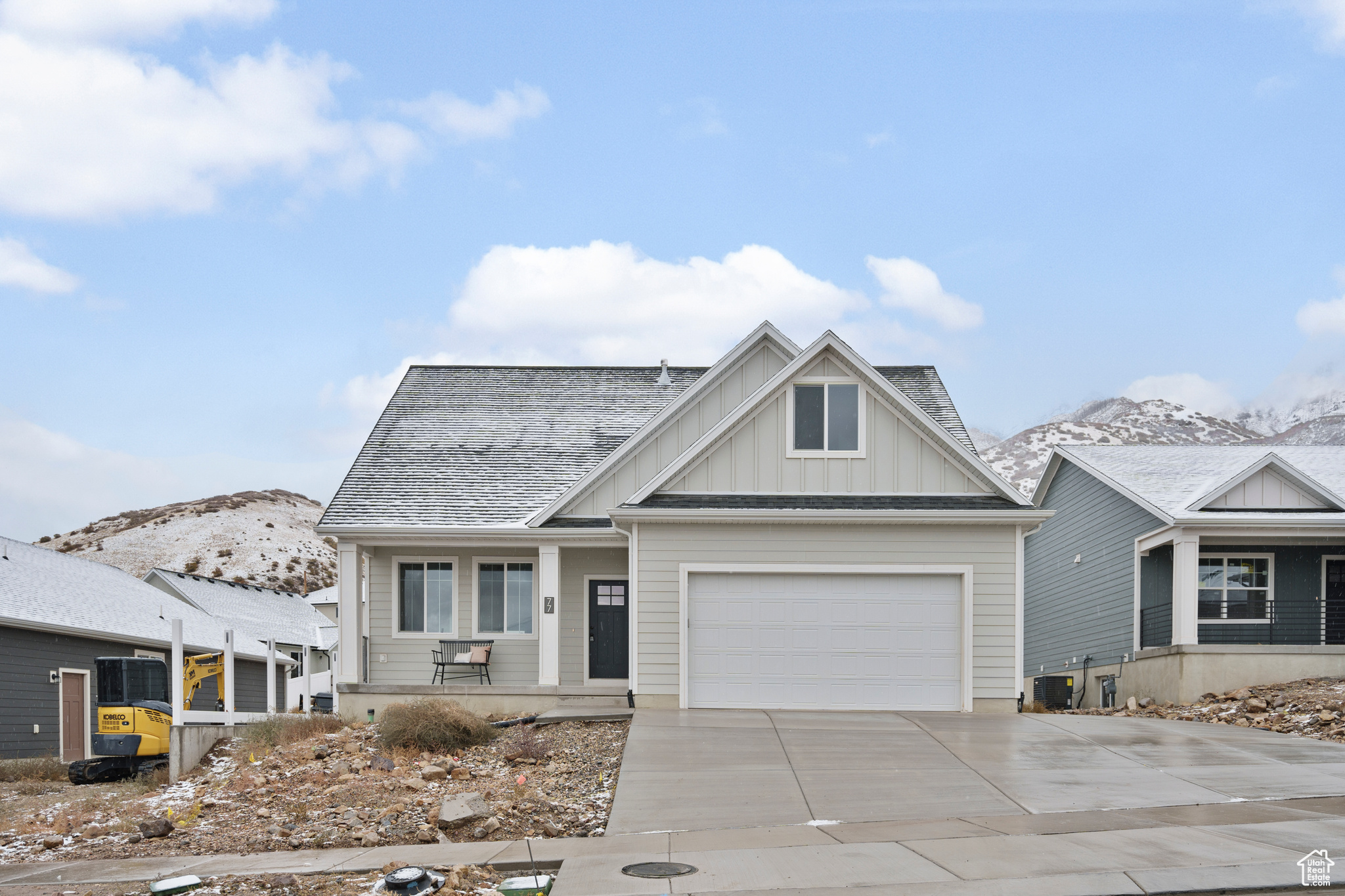 View of front of property featuring a mountain view and a garage