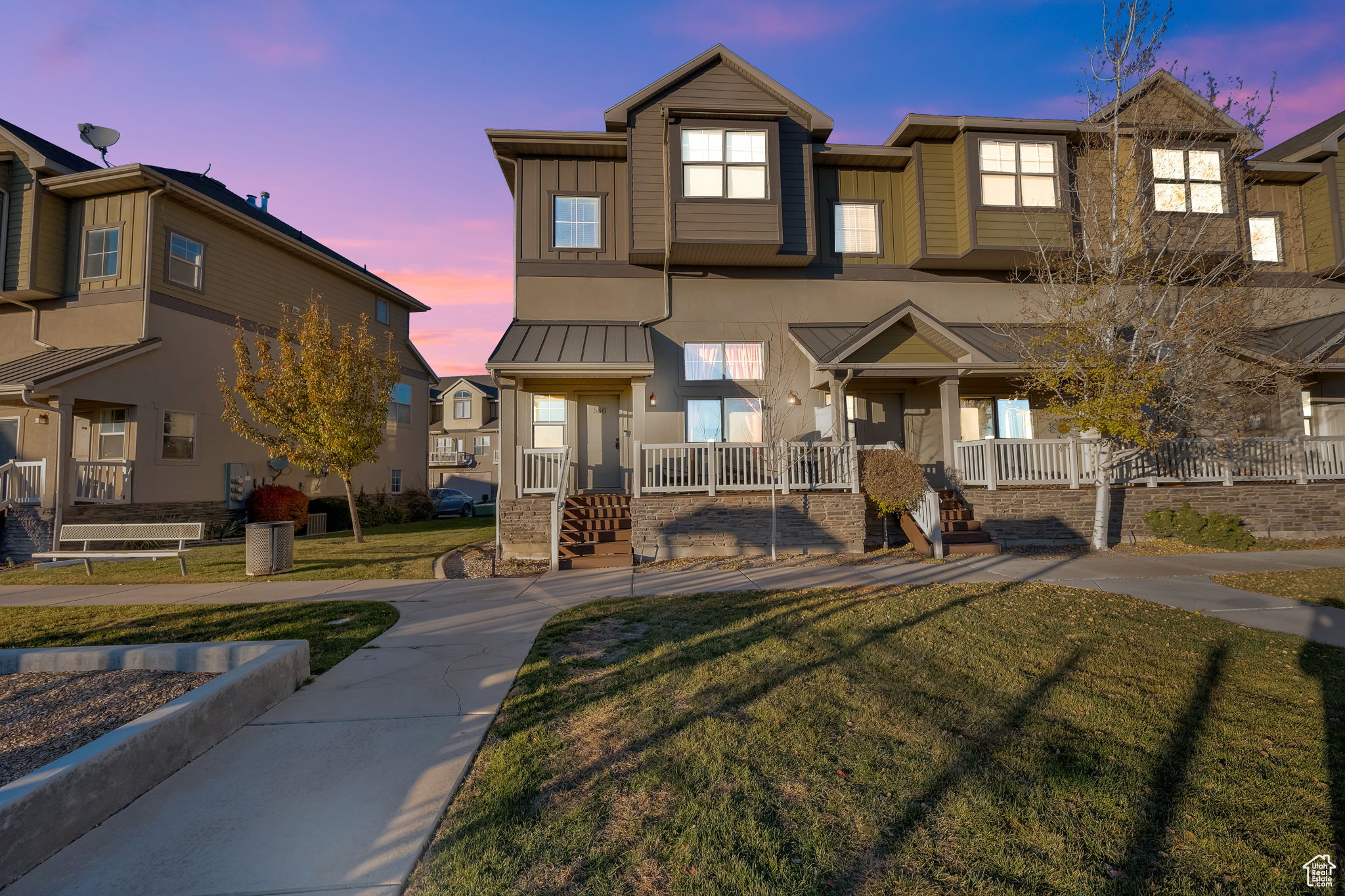 Townhome / multi-family property featuring a yard and a porch