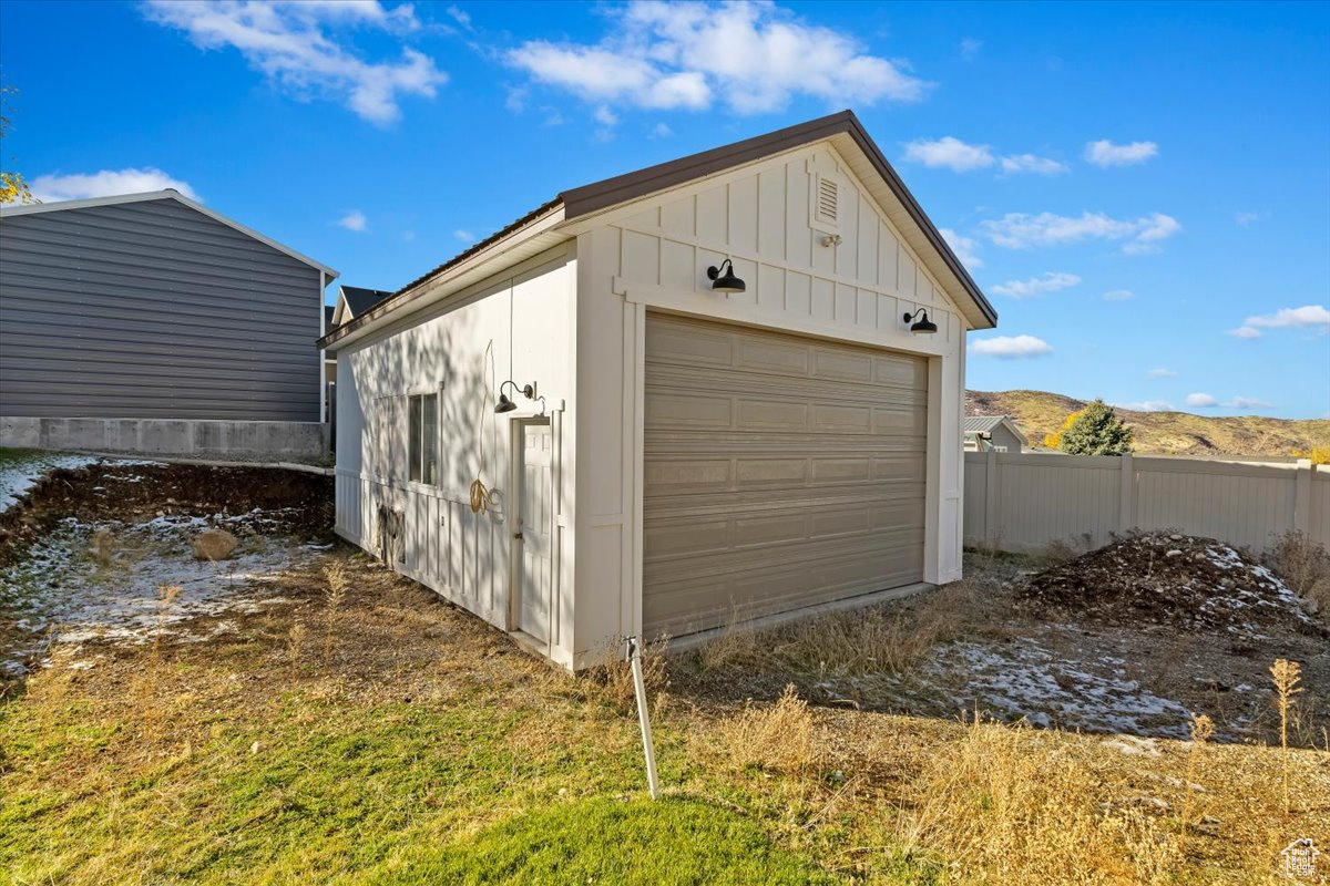 View of outdoor shed featuring a mountain view and a garage door