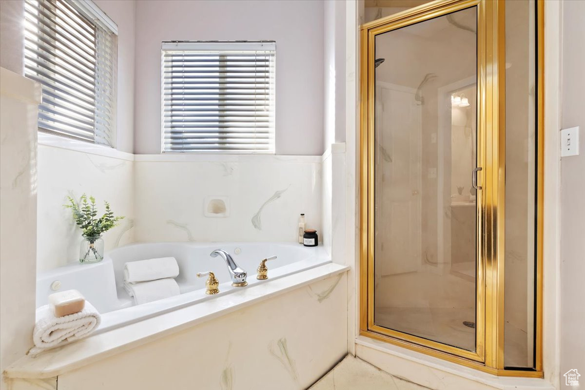 Bathroom featuring shower with separate bathtub